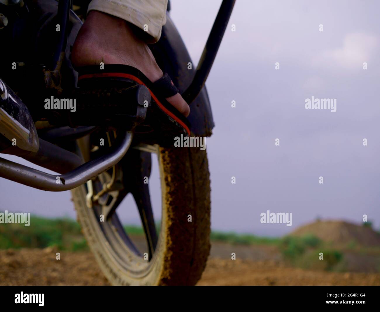 Motorbike side pose with sleeper foot on break at sky background Stock  Photo - Alamy