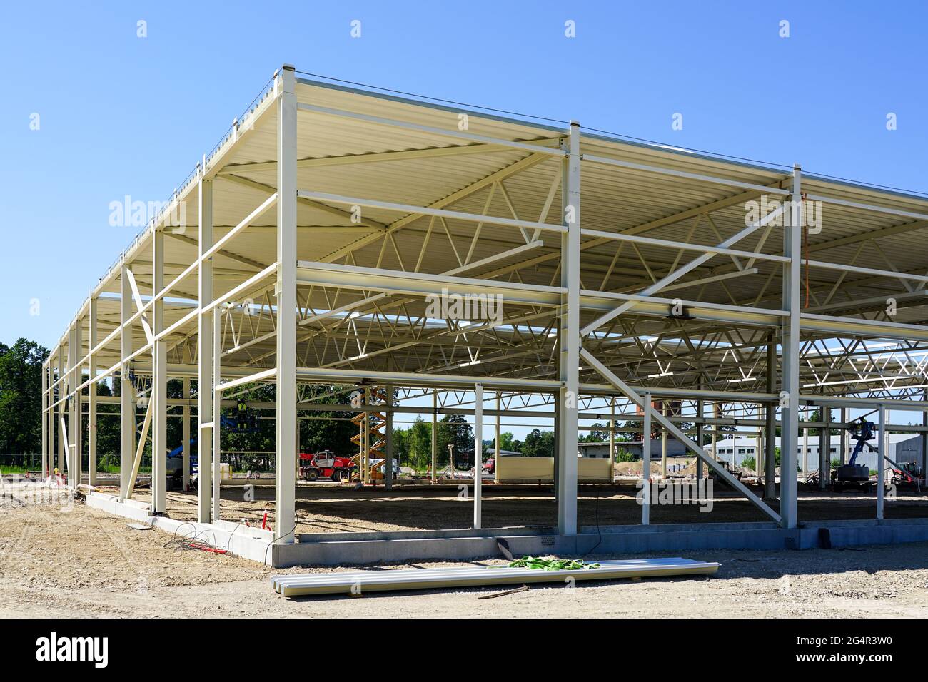 metal frame of a new modern industrial building against a blue sky ...