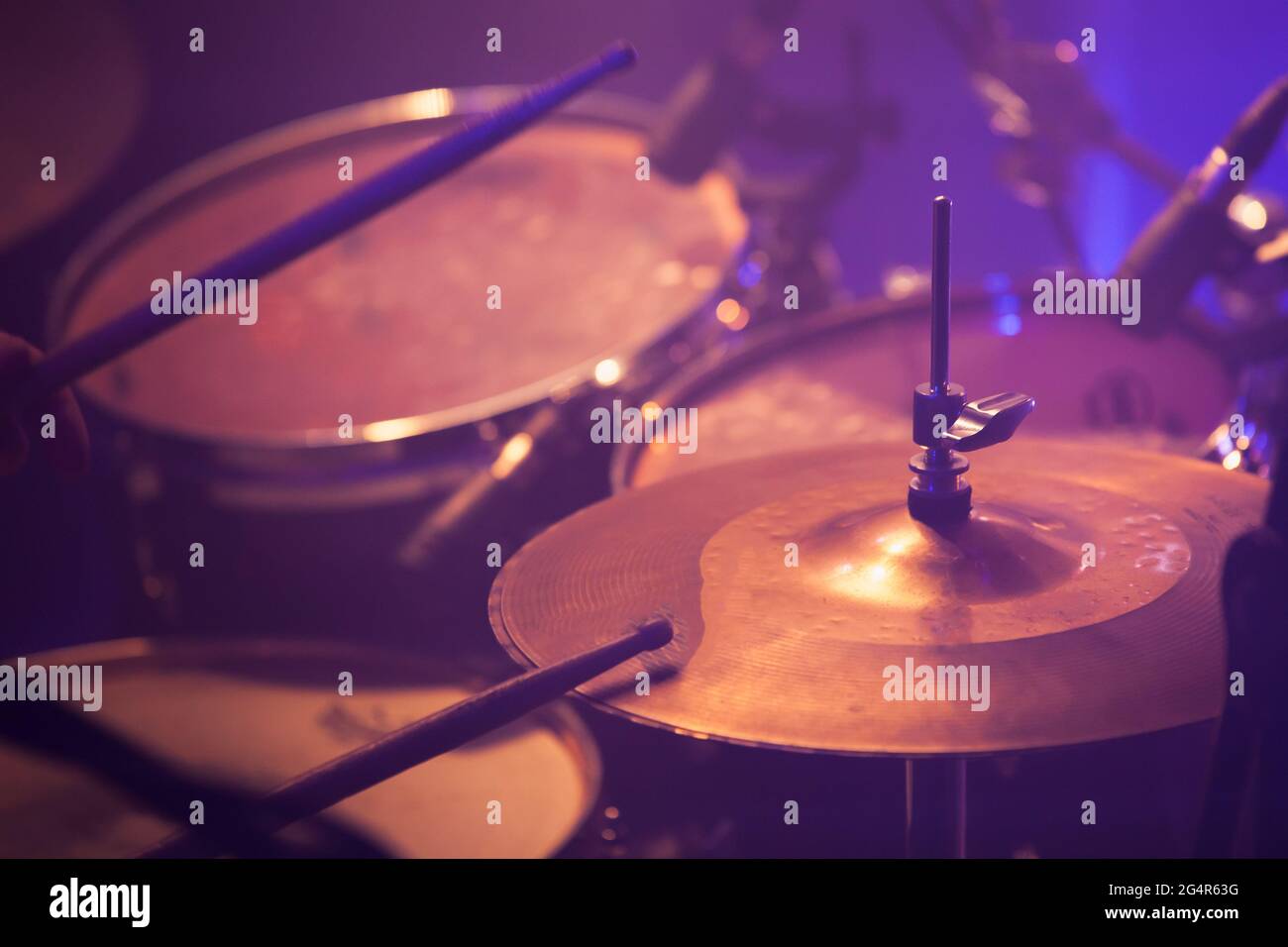 Drum set in stage lights. Close-up photo, soft selective focus. Live music background Stock Photo