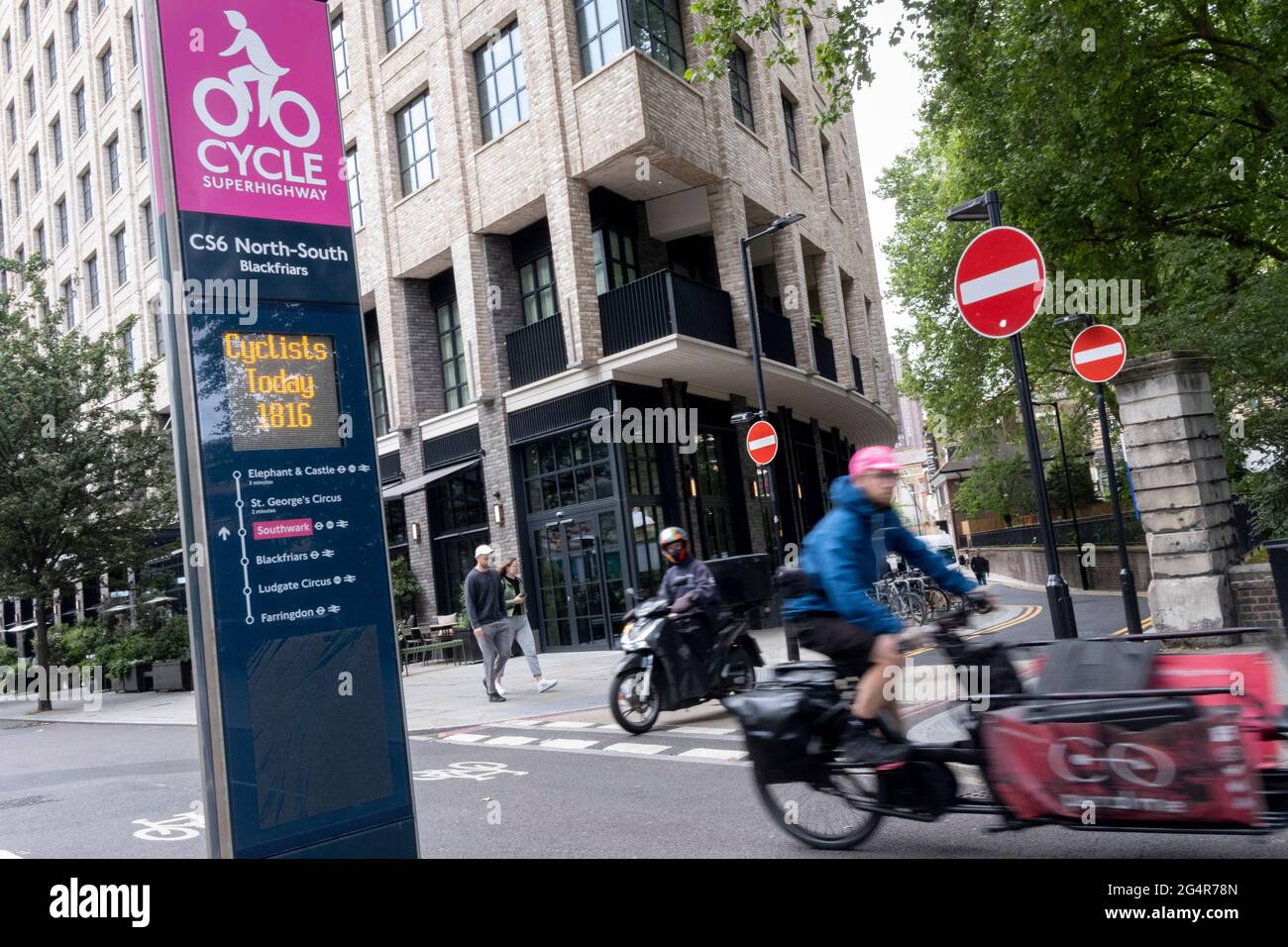 A cyclist rides past daily cycling statistics for the NorthSouth CS6