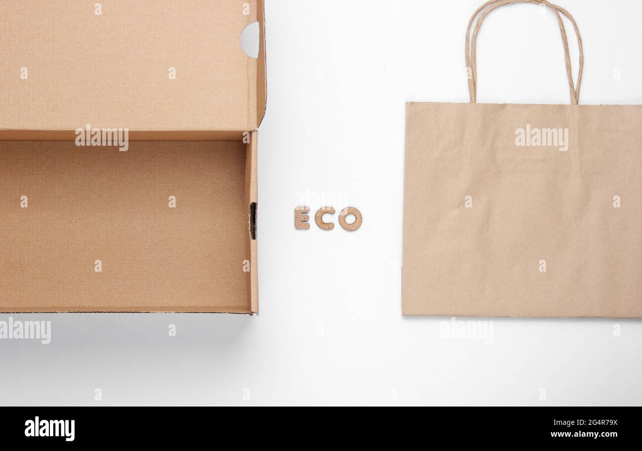 Ecological concept. Cardboard box, paper bag on a white background with the word eco. Top view Stock Photo