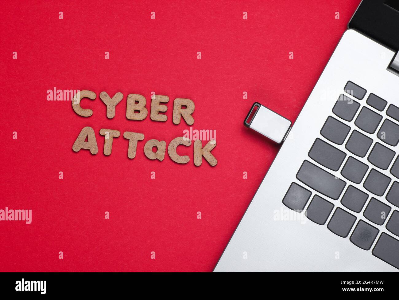 Cyber attack minimal concept. Laptop with flash drive on a red ...
