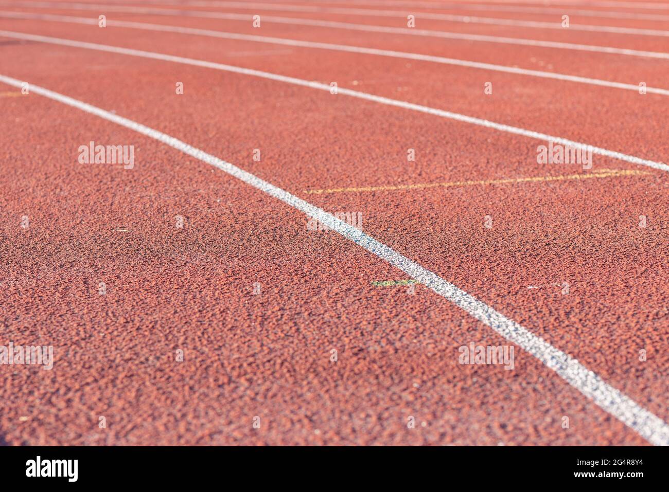 Part Red plastic track in the outdoor track and field stadium.Closeup. Stock Photo