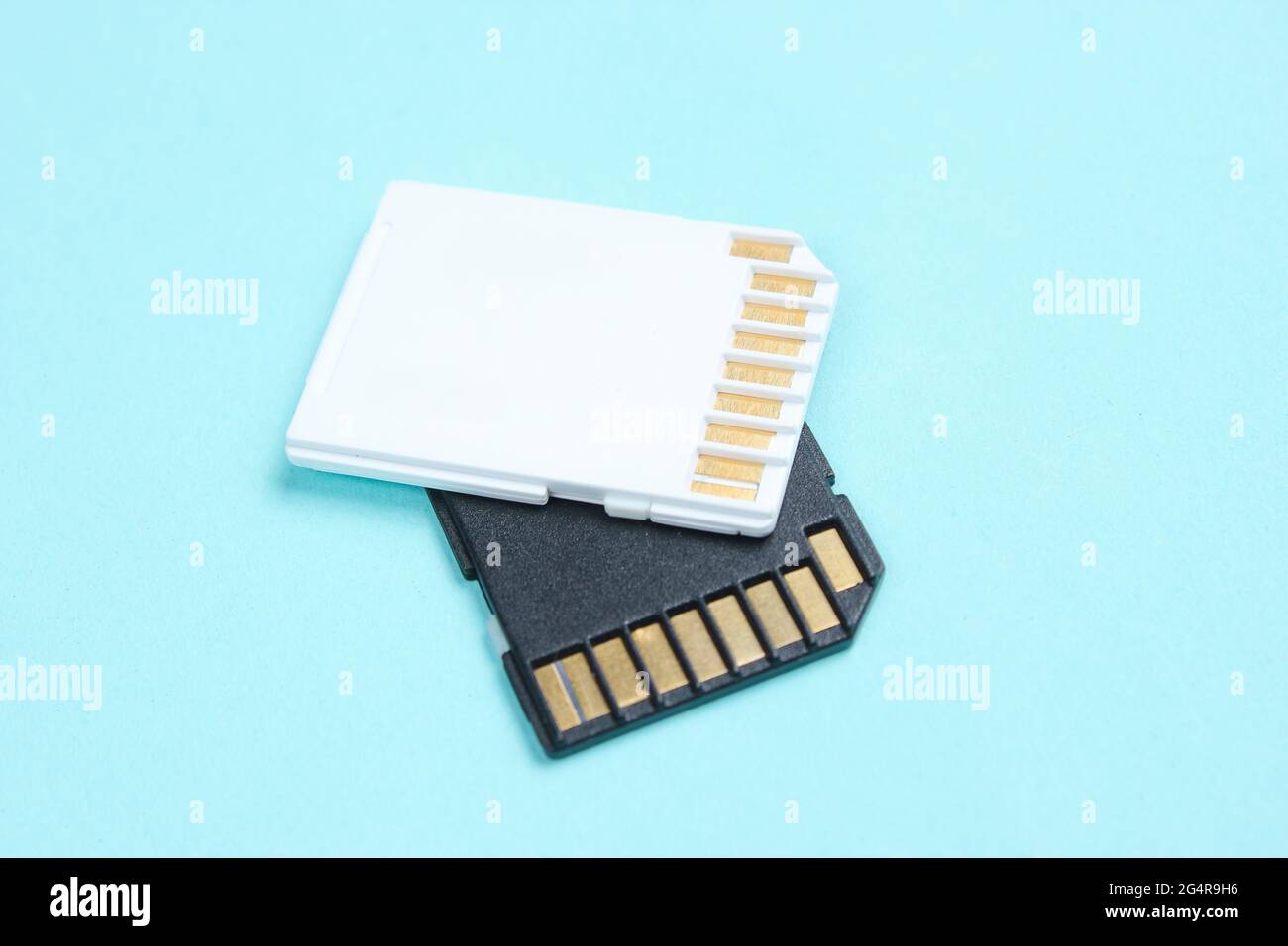 Two Mini SD memory cards on blue background close up Stock Photo
