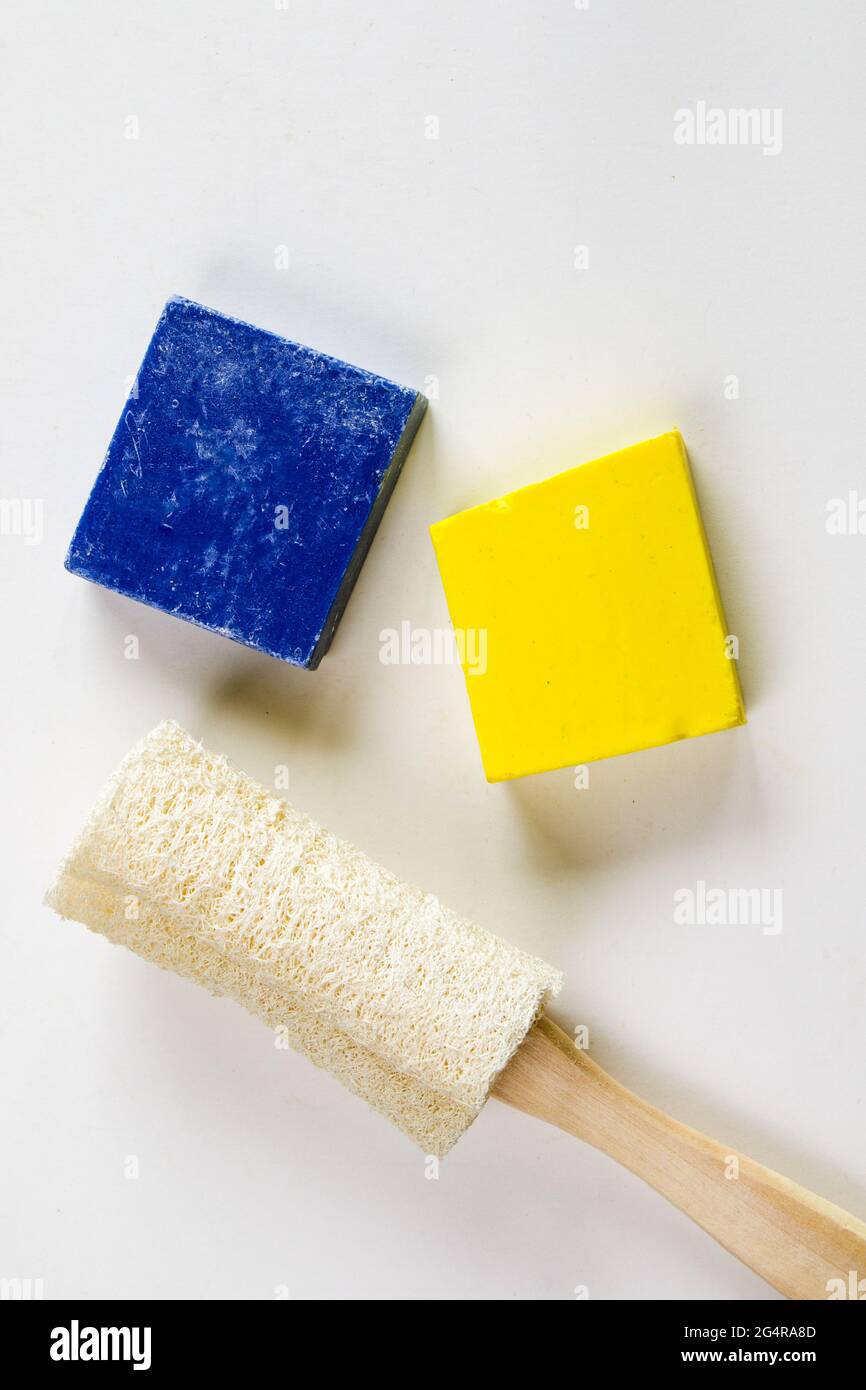 Vertical shot of easily recyclable and ecofriendly sponges on a bright