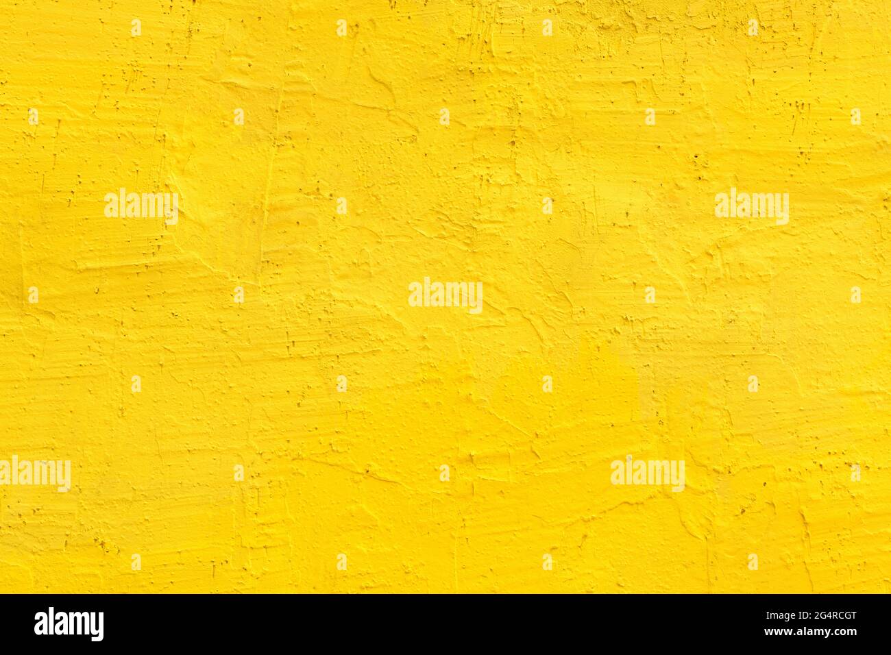 Yellow cement wall as background, unique urban surface texture with vibrant color Stock Photo