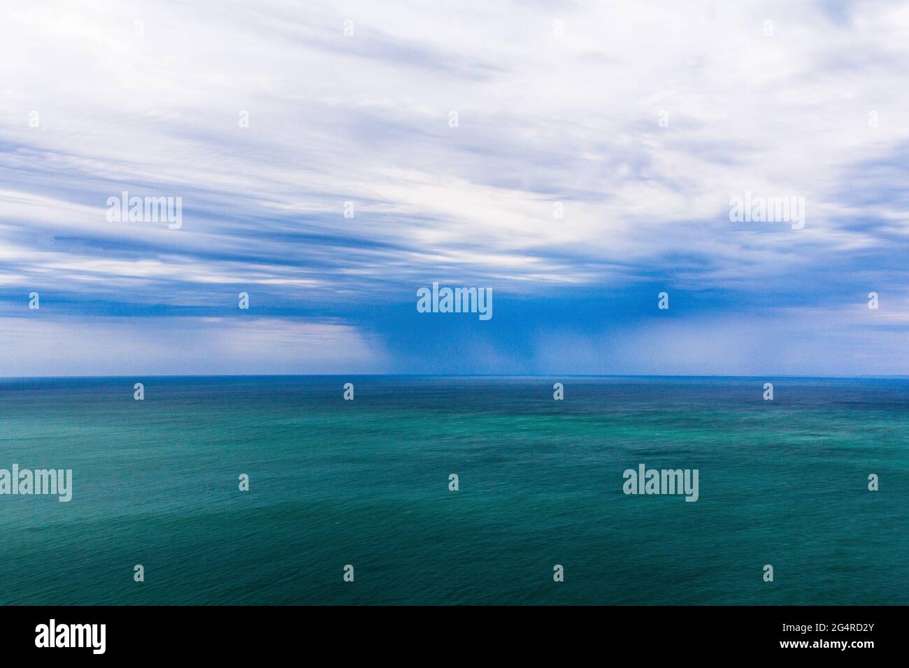 Rain in the sea. The water cycle. Sea and rain. Stock Photo