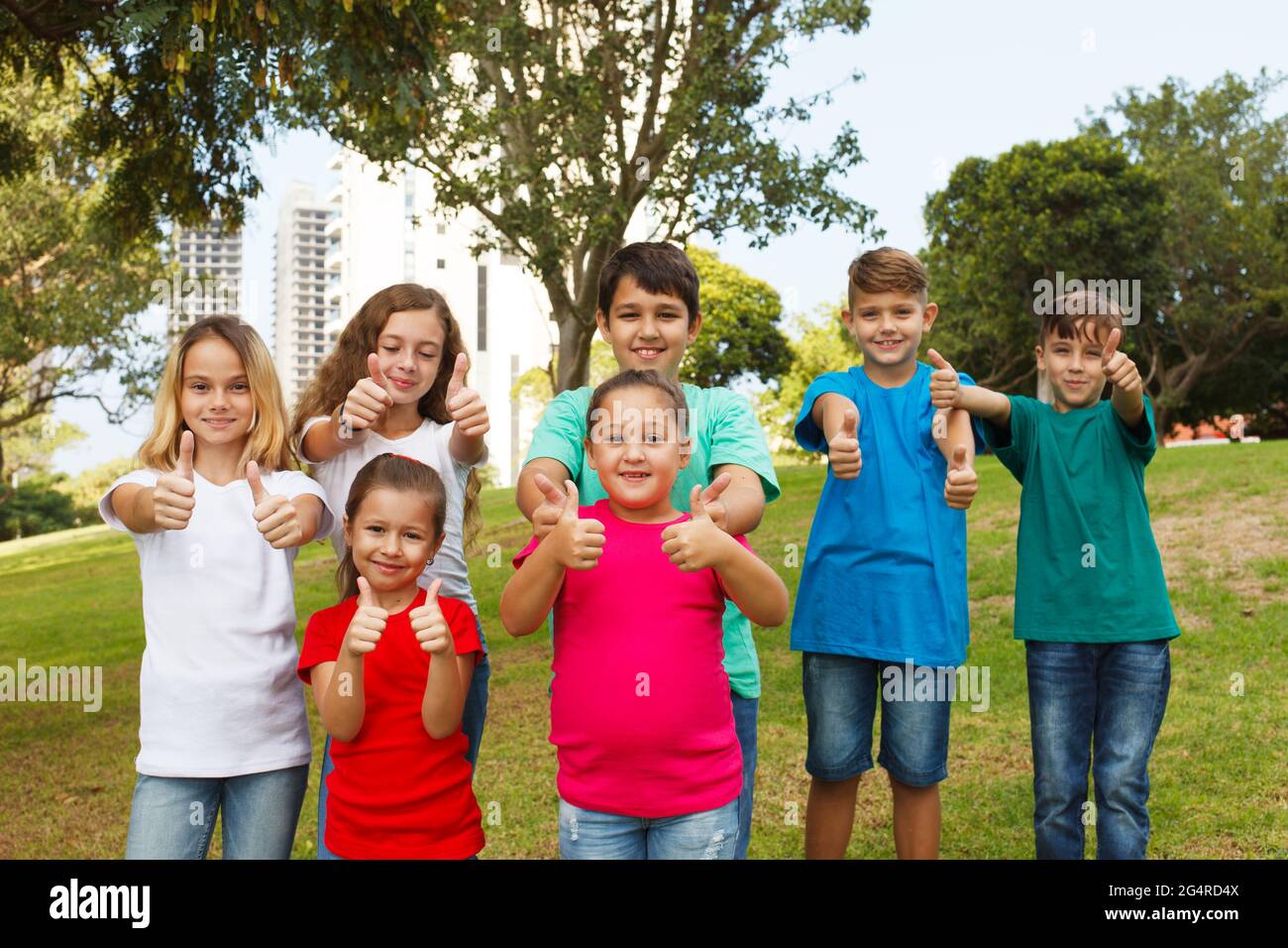 Group of happy children showing thumbs up Stock Photo