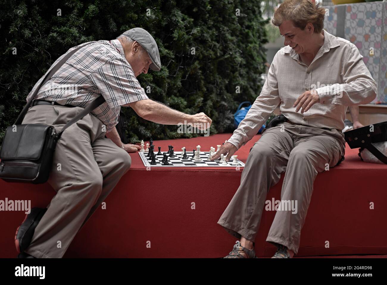 Chess game action and amused player Stock Photo