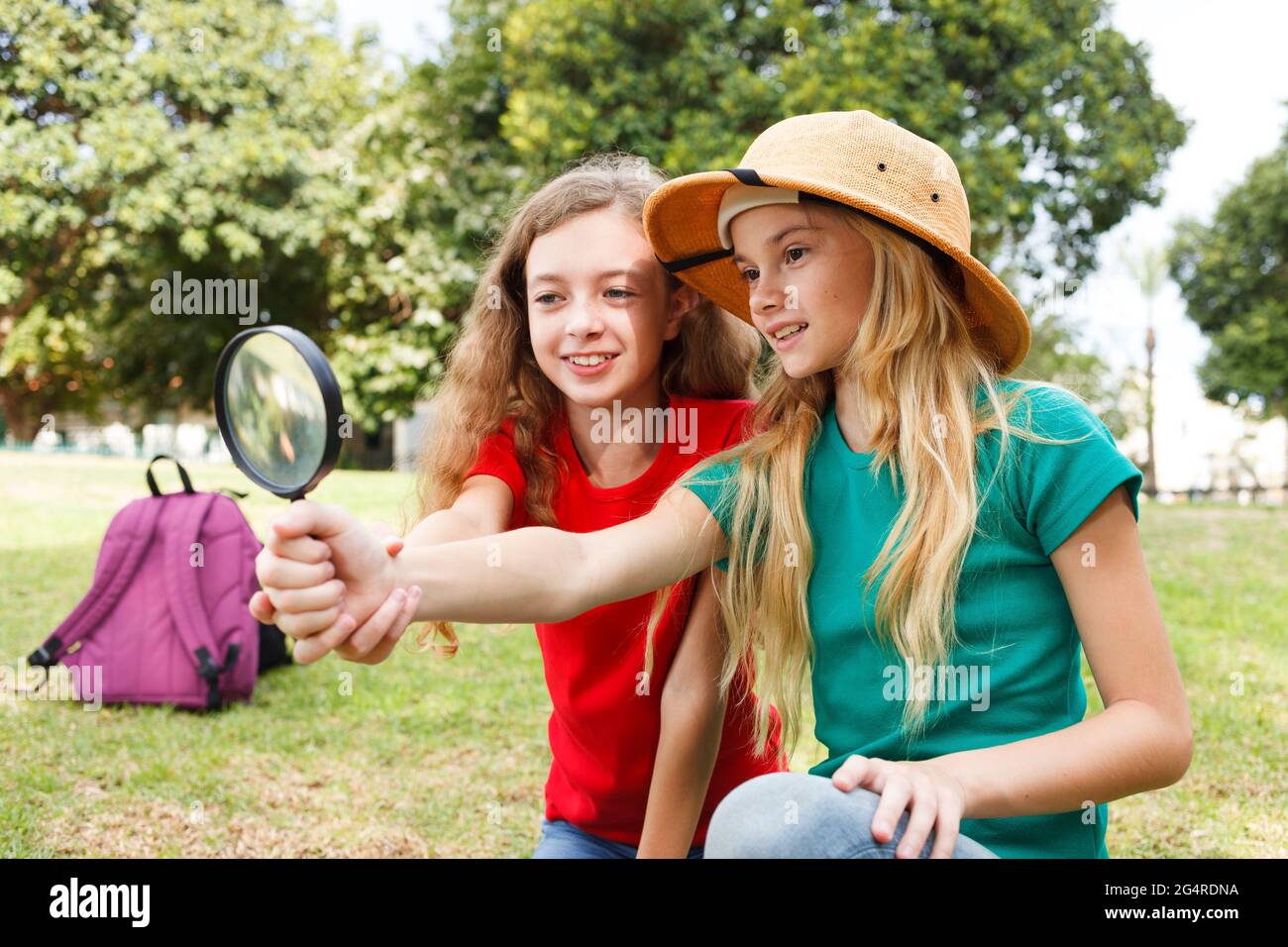 Two girls exploring the nature with magnifying glass Stock Photo Alamy