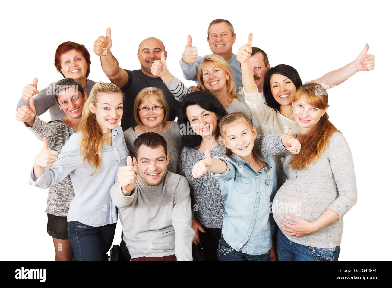 Large group of a Mixed Age people with Disabled Man  smiling together with their thumbs raised up. Isolated on white Stock Photo