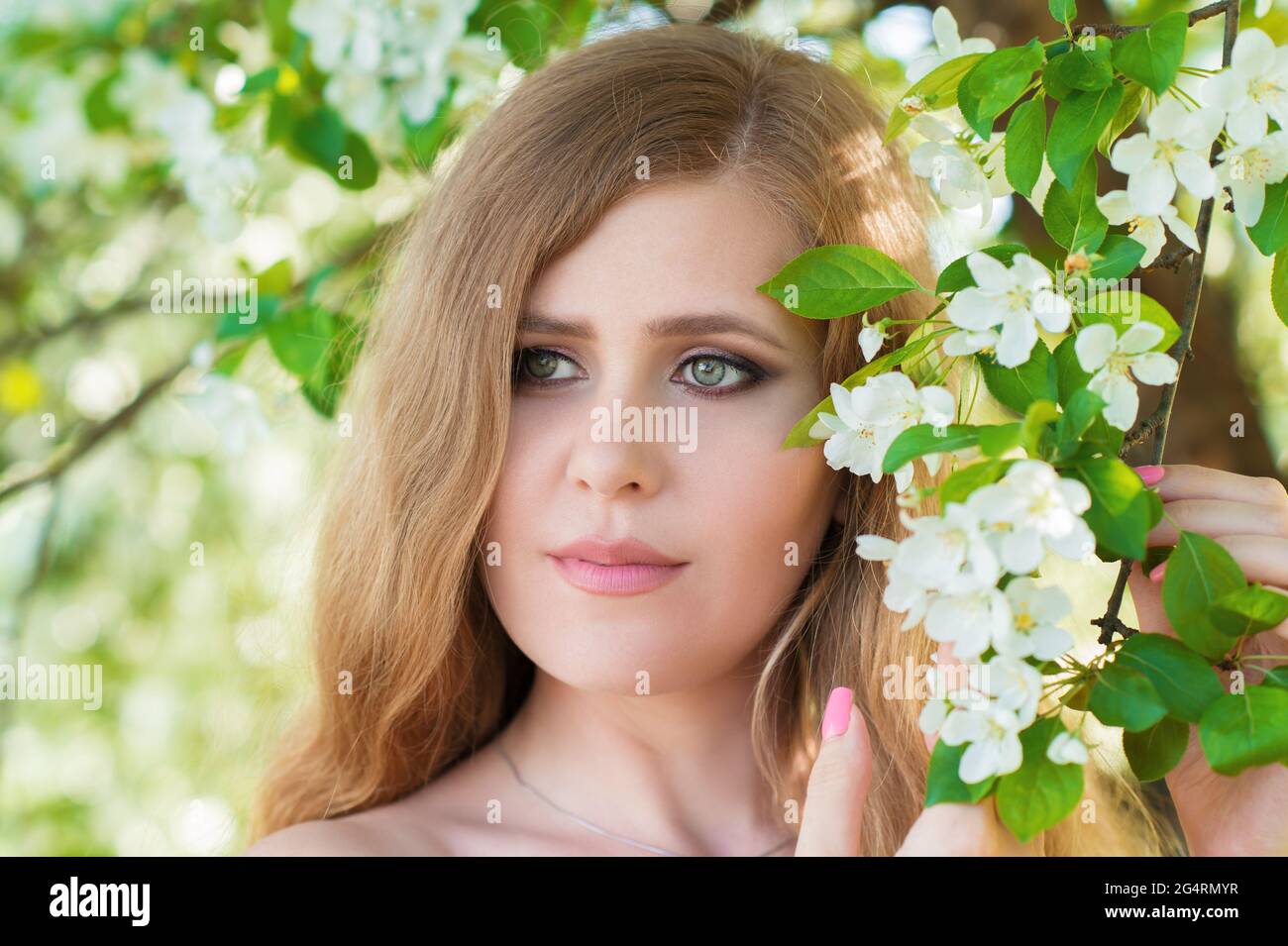 portrait of a woman with flowers in the garden Stock Photo - Alamy