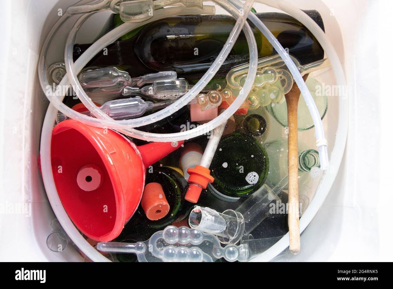 Equipment soaking in a bucket of sterilising solution to clean before
