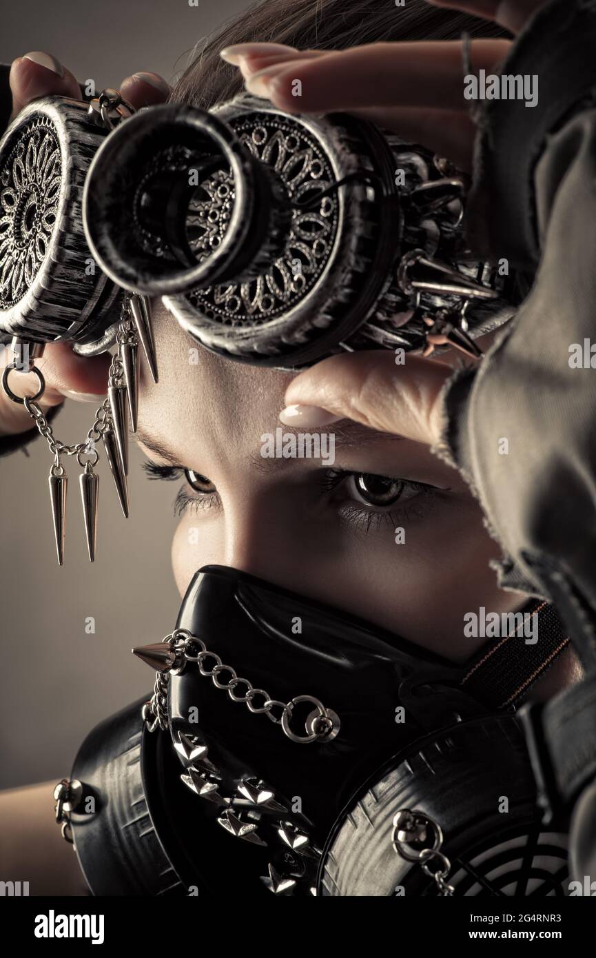 brutal woman in uniform and steampunk mask with axe Stock Photo