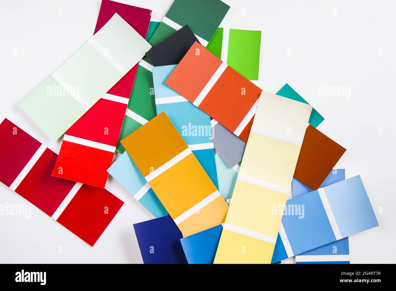 Top view of a large variety of color charts piled together in a messy ...