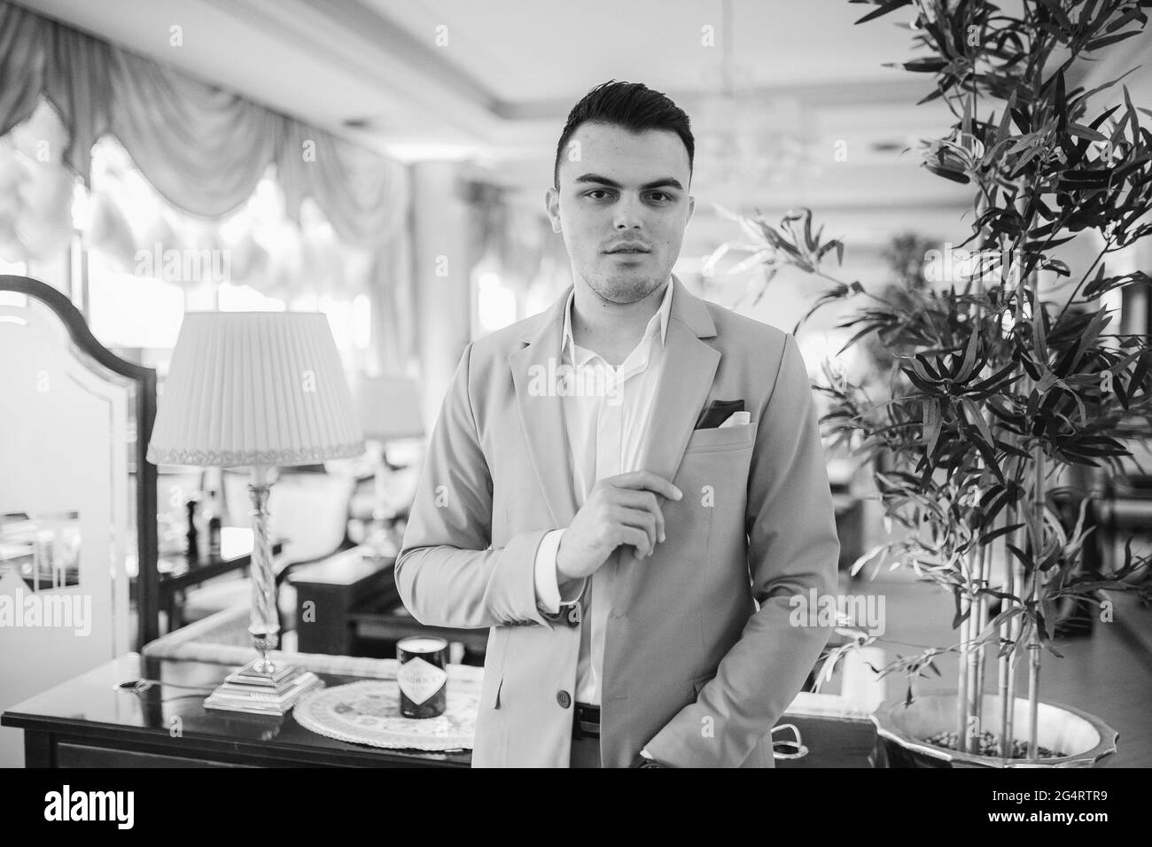 Caucasian young businessman in a suit standing in the restaurant Stock ...