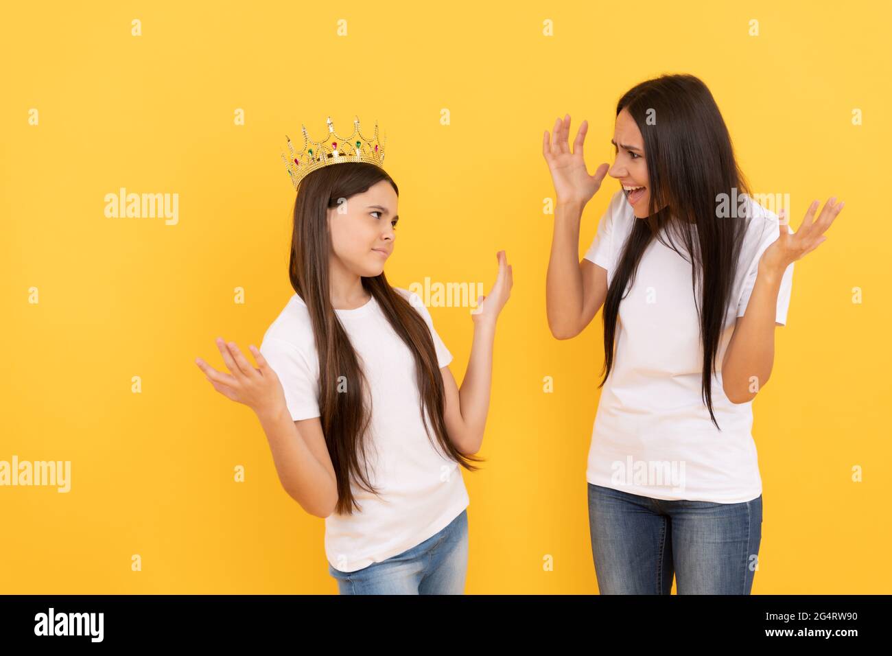 angry mom scold stubborn fussy kid. ignore parent. shout at difficult child. smug. Stock Photo