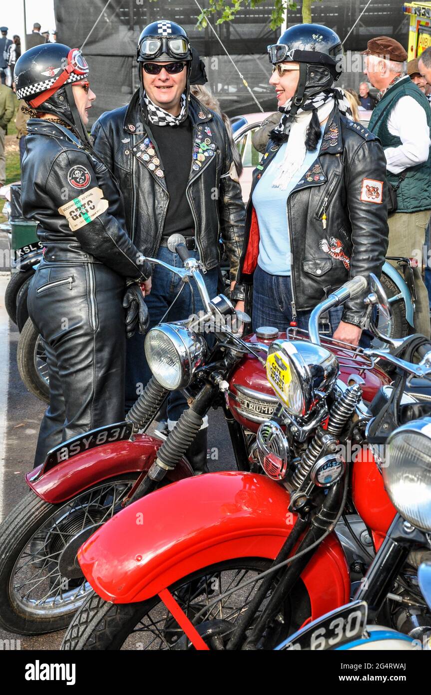 Motorcyclists in vintage motorcycle clothing with classic motorbikes at the  Goodwood Revival 2011, UK. Male and females in black leather riding gear  Stock Photo - Alamy
