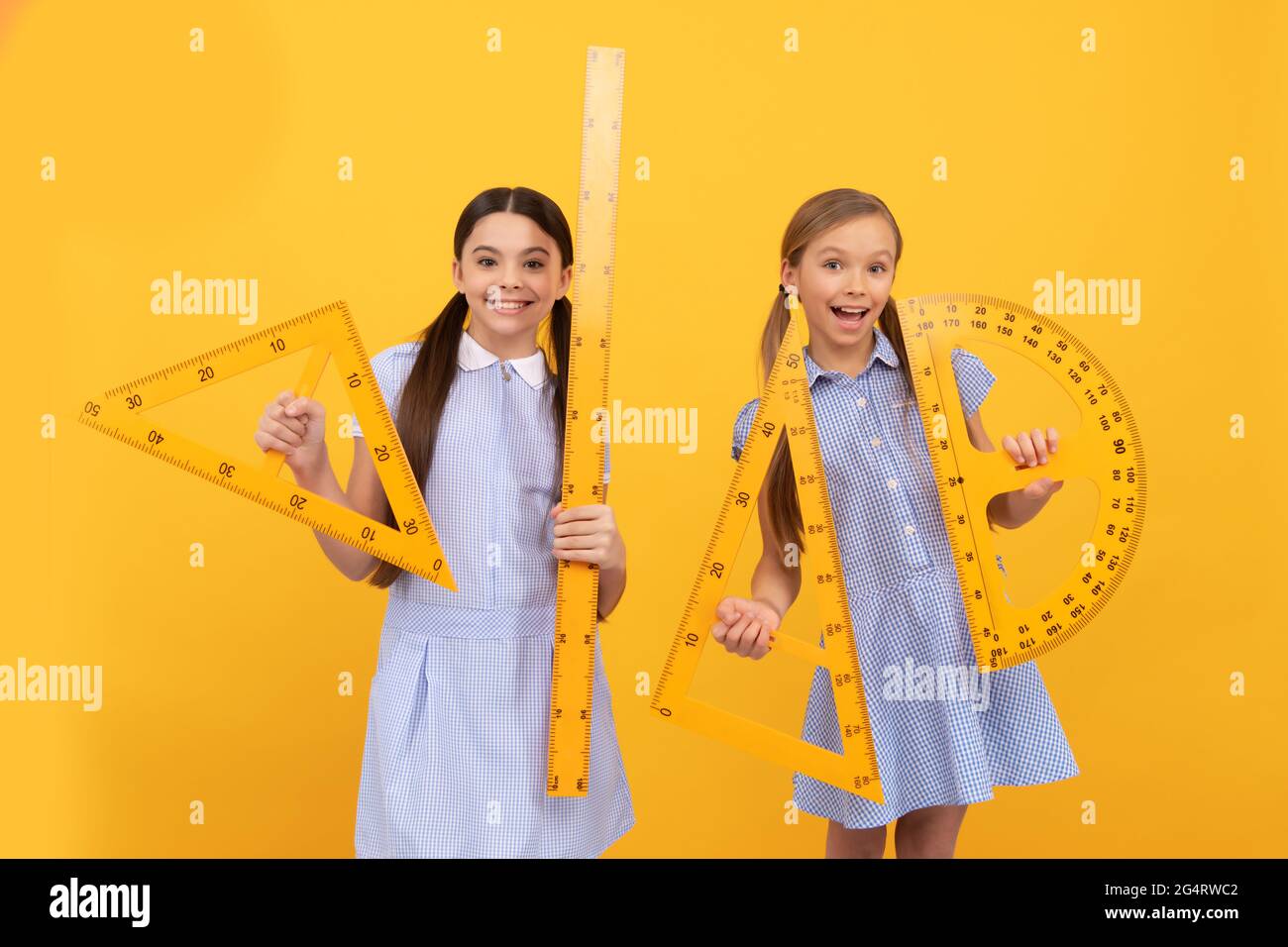 Happy school age children hold geometric tools for geometry lesson ...