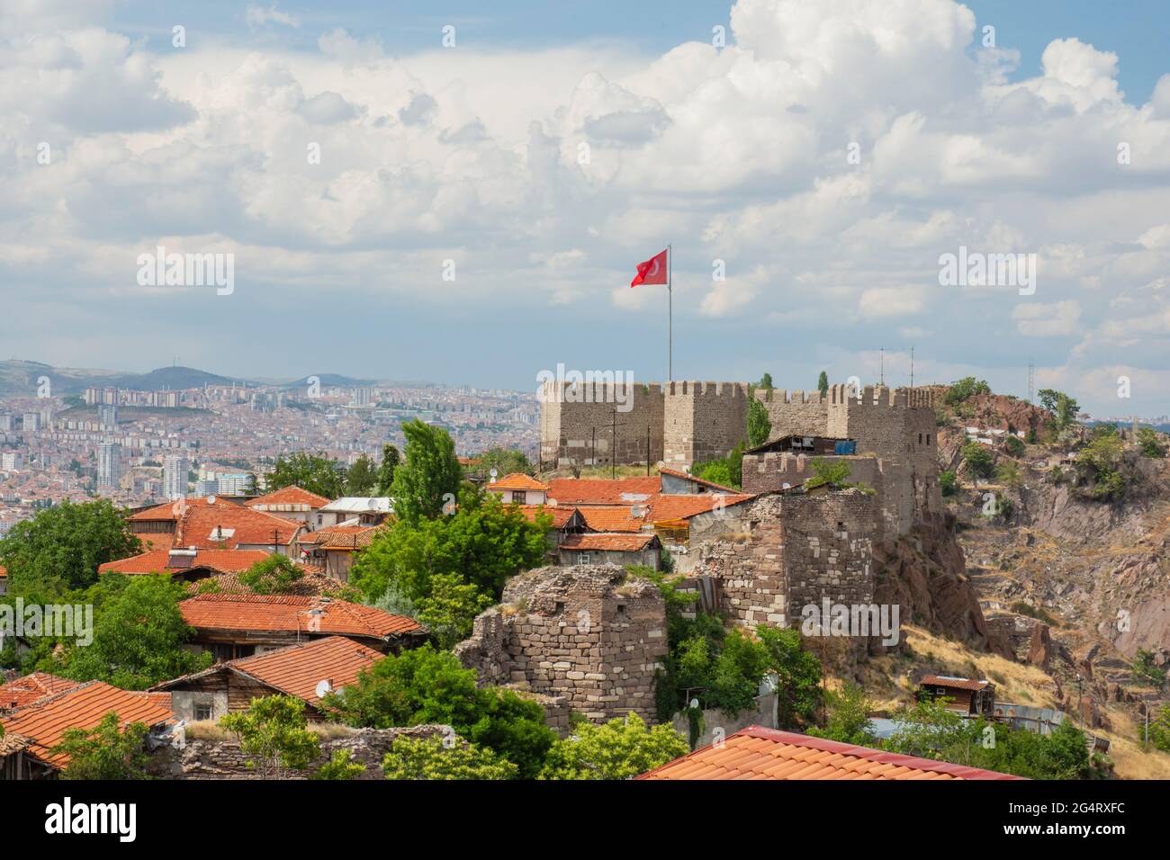 Panoramic of Ankara castle and Turkish flag in Post under cloudy blue sky Stock Photo