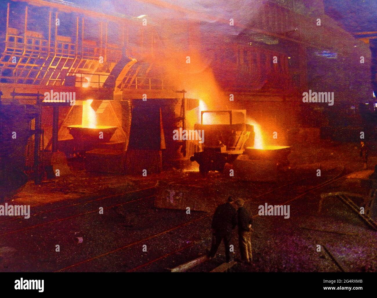 A colour photograph of c1940's  the 'Slagging off' process at a British steel works with open hearth furnaces Stock Photo