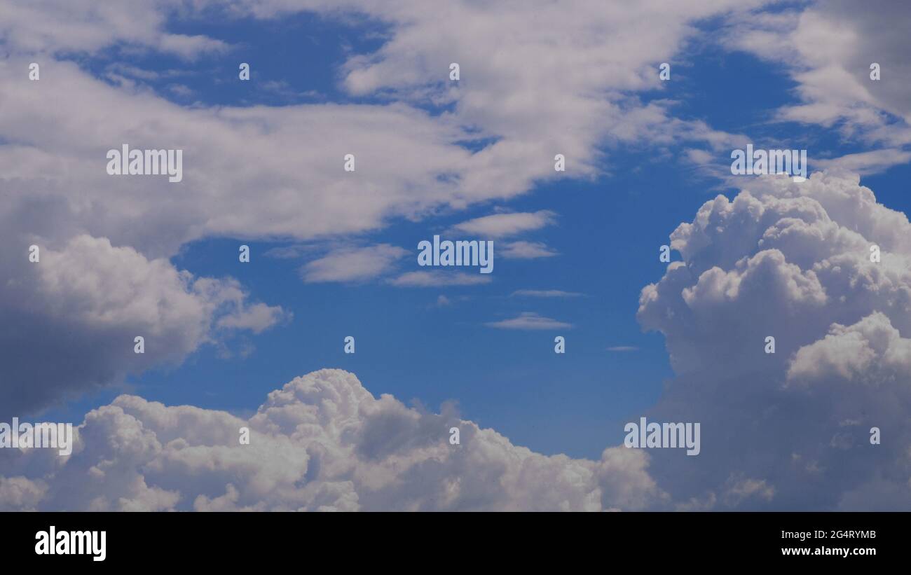 contrasting sky, blue-blue sky, pale white blue sky with scattered cumulus clouds, summer blue sky soft clear. Puffy cloud moving on a windy beach Stock Photo