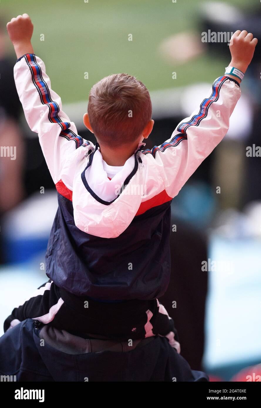 London, UK. 22nd June 2021 - England v Scotland - UEFA Euro 2020 Group D Match - Wembley - London  A young England fan celebrates victory on his Dad's shoulders during the Euro 2020 match against Czech Republic. Picture Credit : © Mark Pain / Alamy Live News Stock Photo