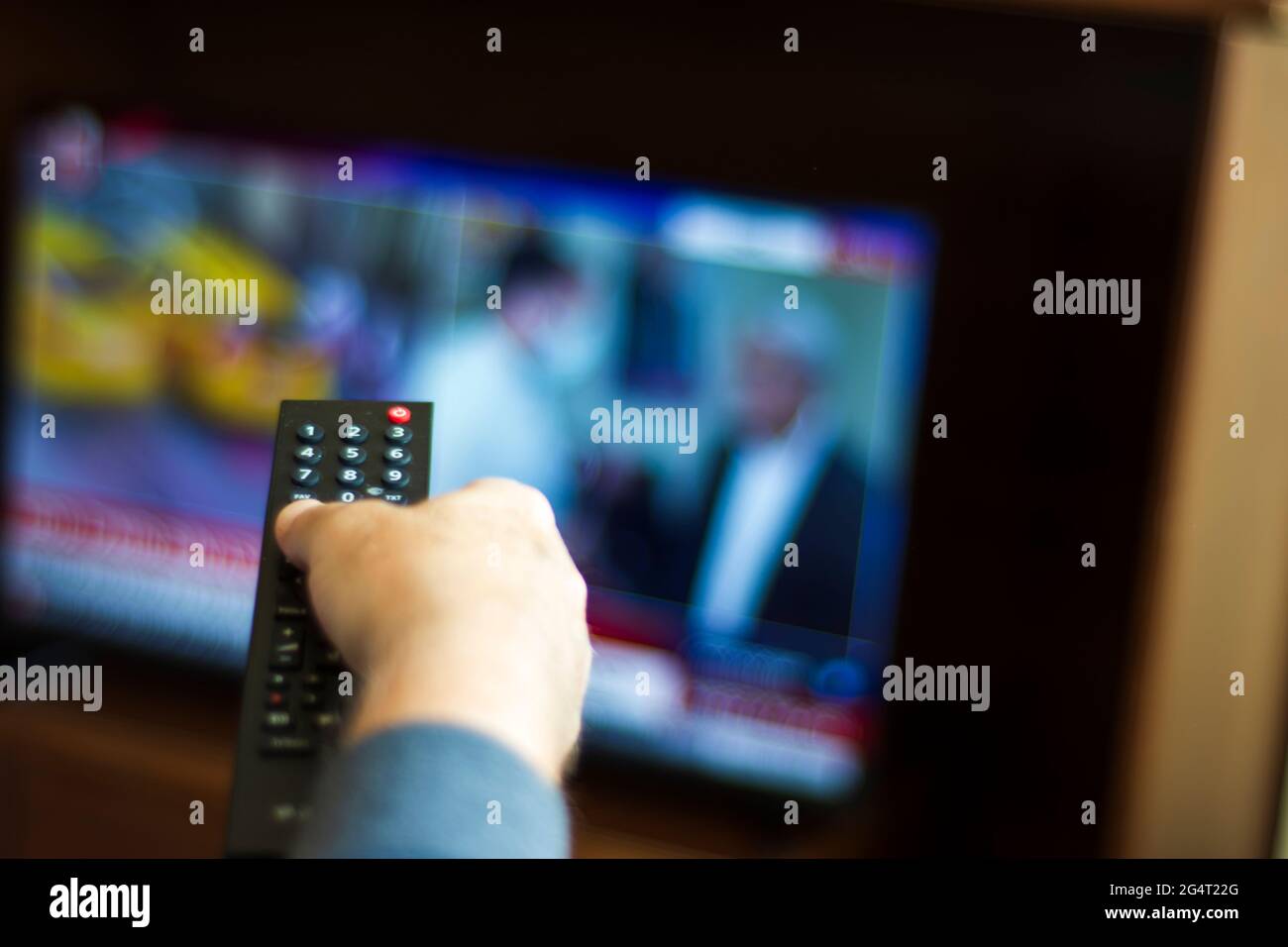 Someone who constantly changes channels while watching TV. selective focus remote control Stock Photo