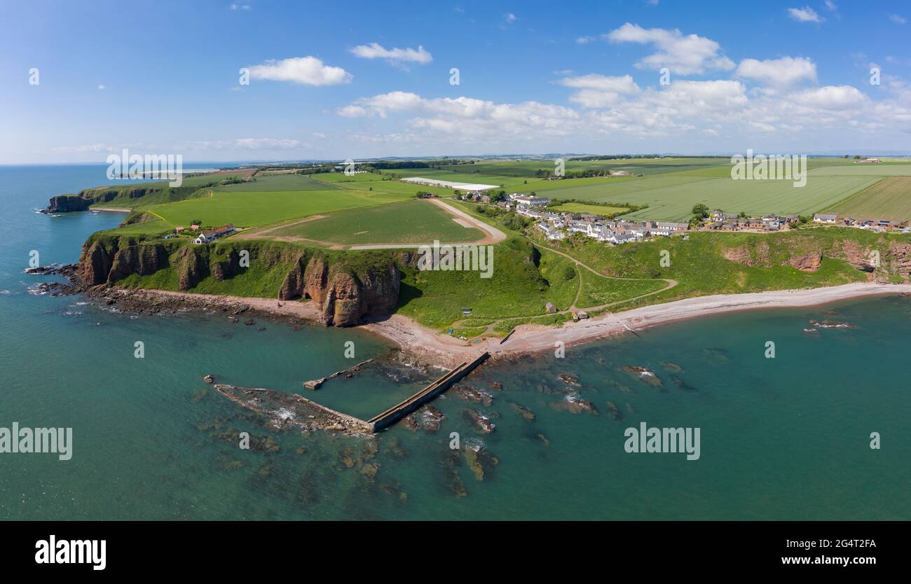Aerial view of the cliff top village of Auchmithie and it's beach and old harbour. Auchmithie was where the Arbroath Smokie was first produced. Stock Photo