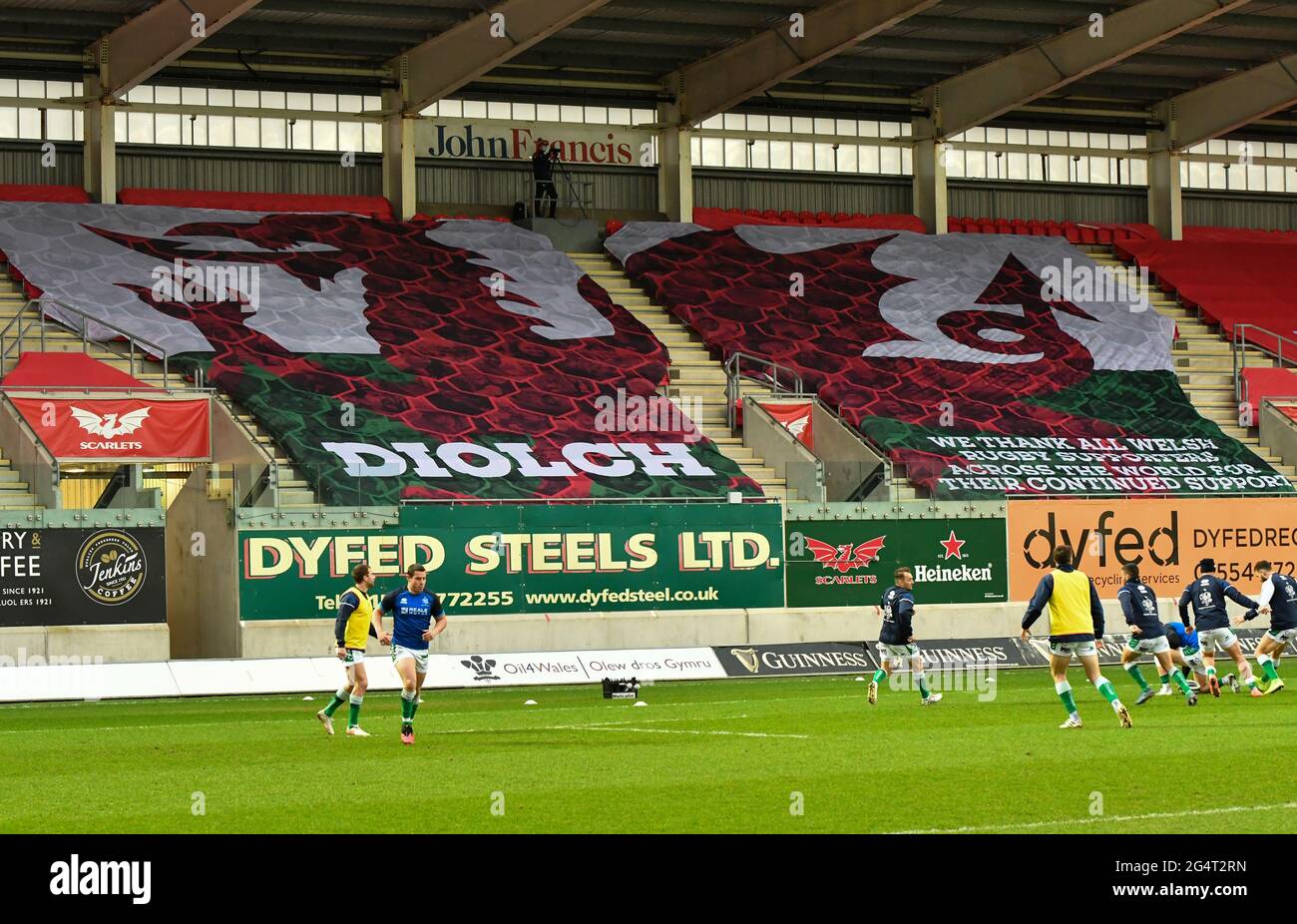 Llanelli, Wales. 20 February, 2021. A large Welsh flag covering the seats of the stadium before the Guinness PRO14 match between Scarlets and Benetton at Parc y Scarlets in Llanelli, Wales, UK on 20, February 2021. Sporting stadiums around the UK remain under strict restrictions due to the Coronavirus Pandemic as Government social distancing laws prohibit fans inside venues resulting in games being played behind closed doors. Credit: Duncan Thomas/Majestic Media. Stock Photo