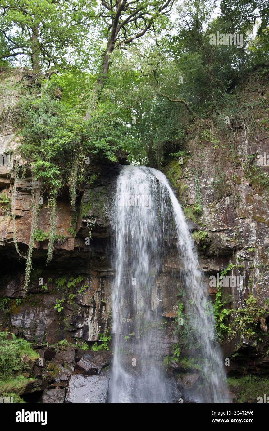 Melincourt Waterfalls, Neath, Wales, taken with a normal, fast shutter speed to freeze the water as it cascades down onto rocks Stock Photo