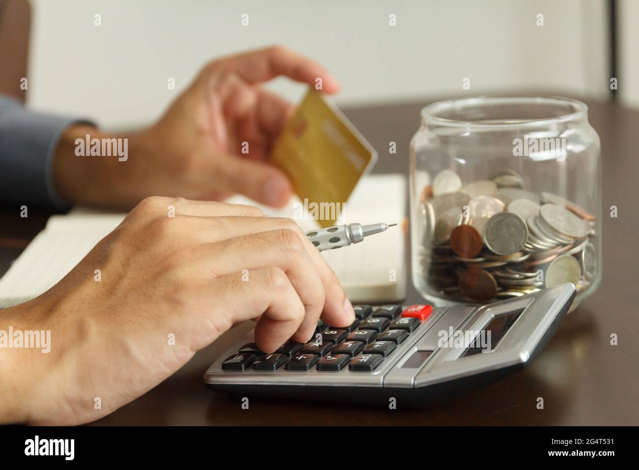 Money management concept. Hand man use calculator to calculate the