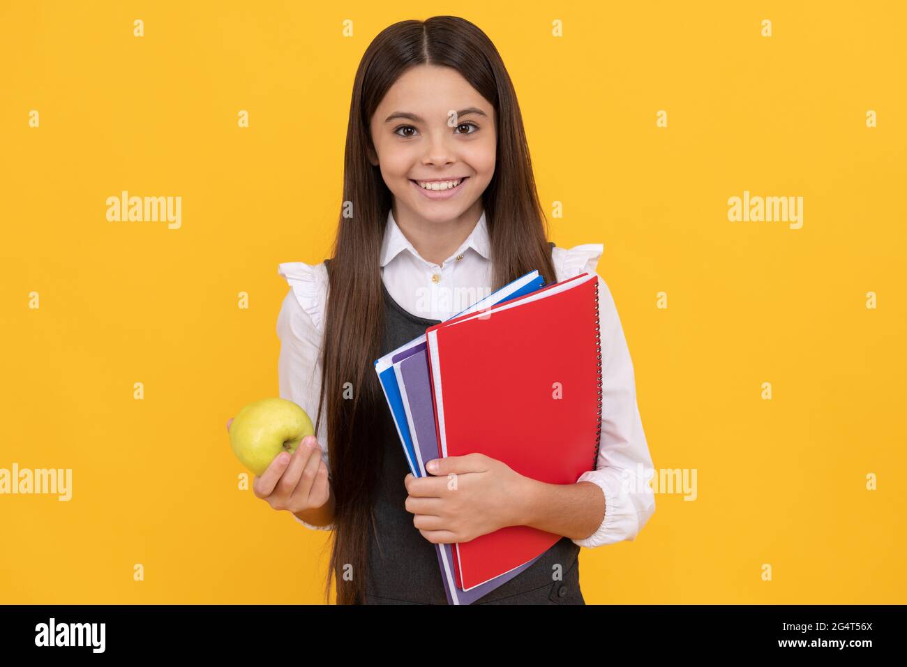 Knowledge is delicious. Happy schoolchild hold apple and books. Knowledge day Stock Photo