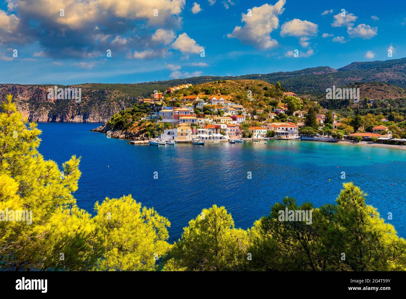 Assos village in Kefalonia, Greece. Turquoise colored bay in Mediterranean sea with beautiful colorful houses in Assos village in Kefalonia, Greece, I Stock Photo