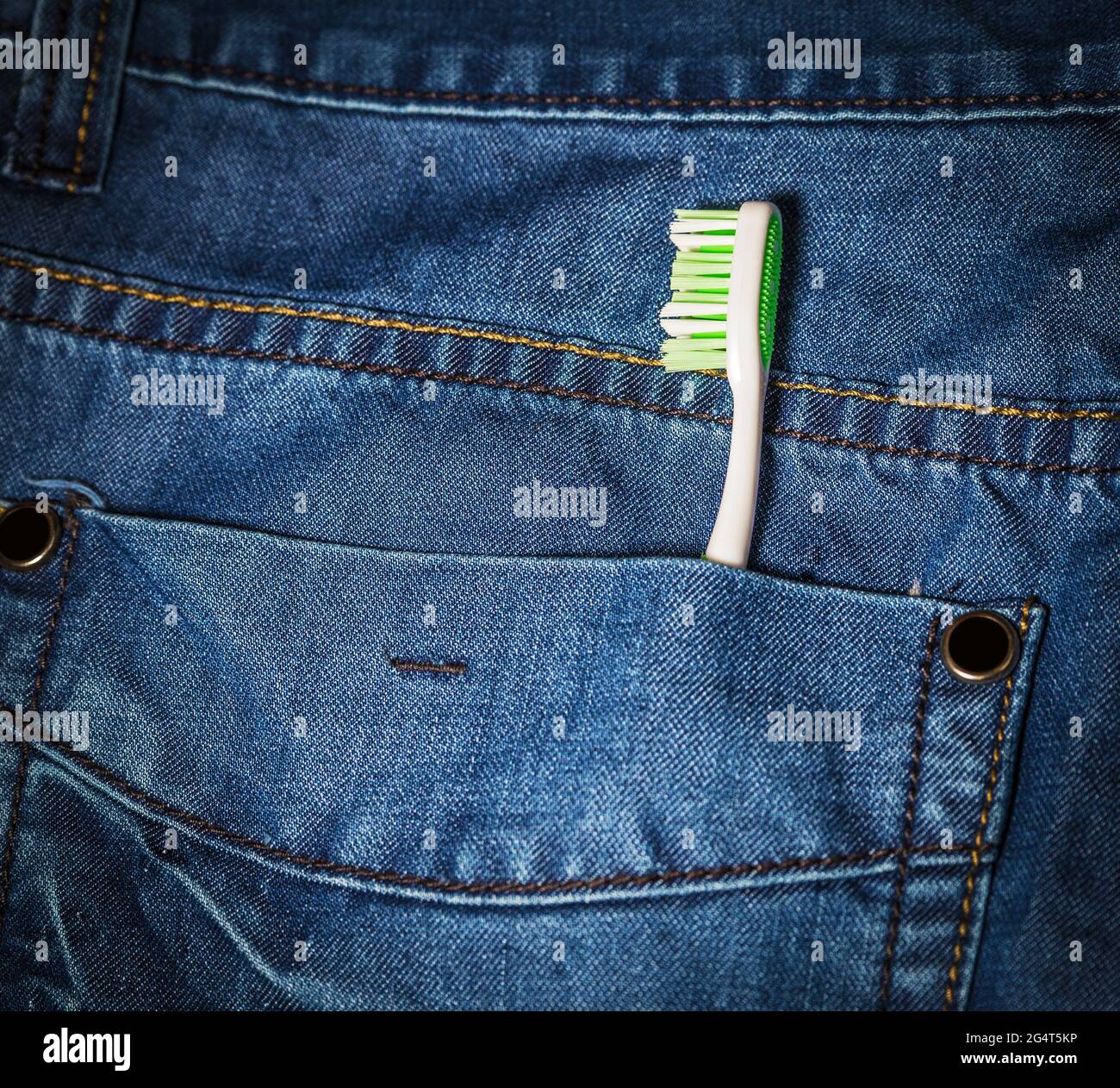 Toothbrush out of jeans pocket. Dental 