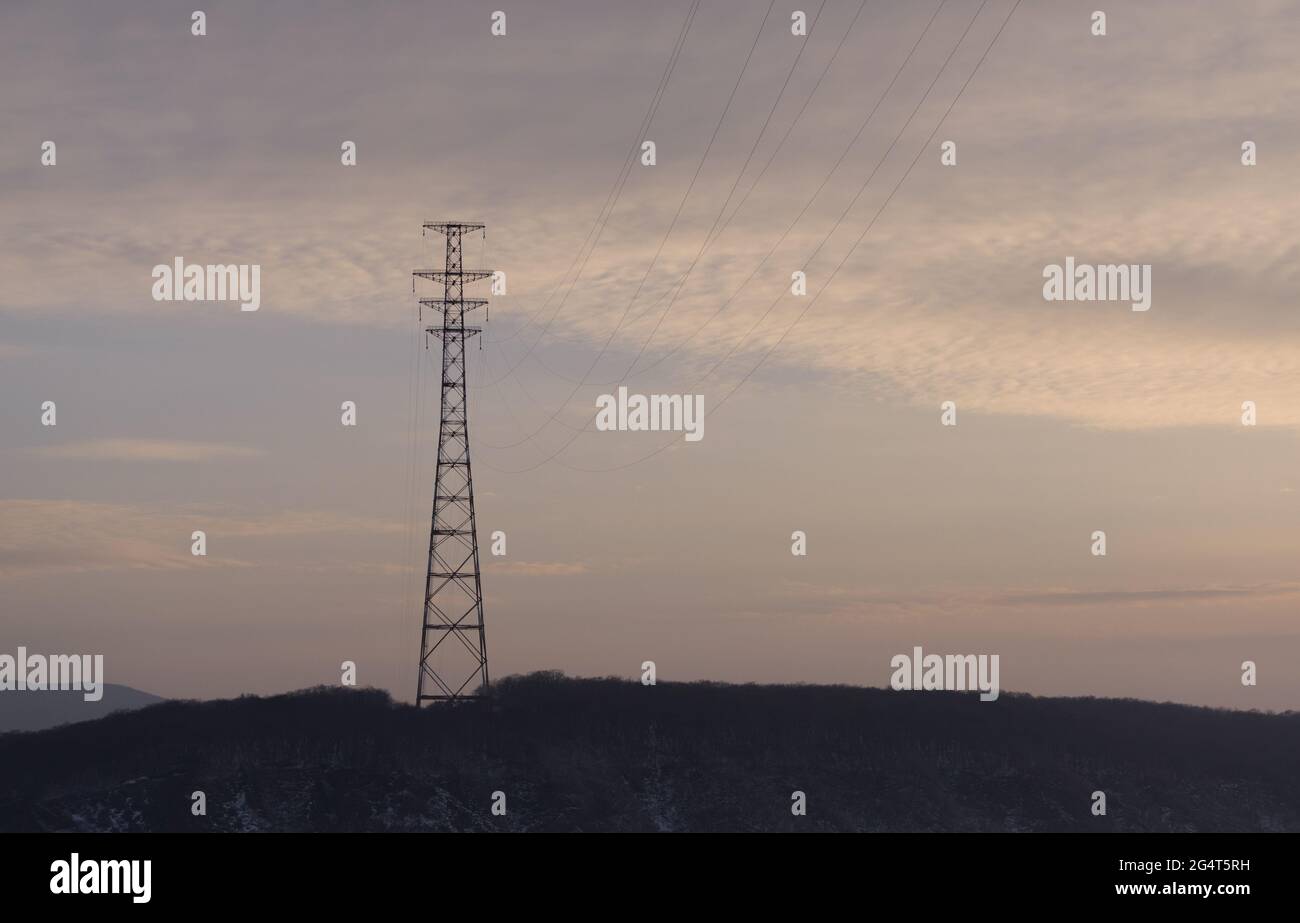 Hight-voltage electric power lines at sunset. Stock Photo