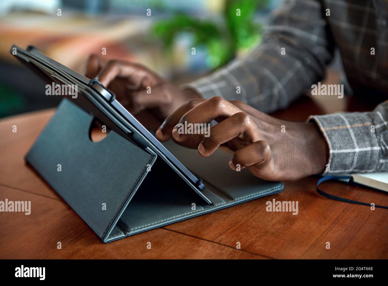 African businessman working from home using a digital tablet Stock Photo