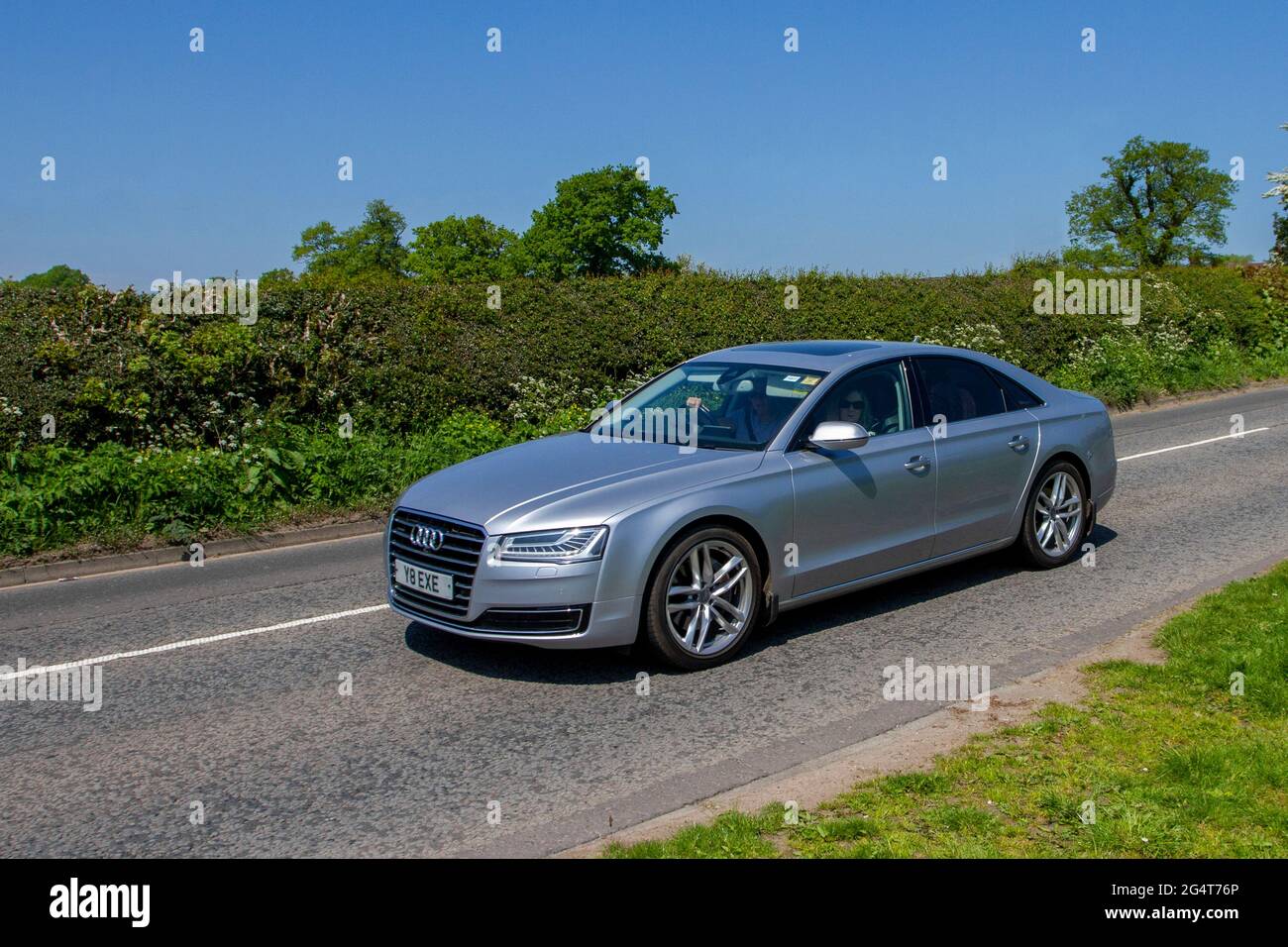 2015 silver Audi A8 2967cc diesel 4dr saloon, vehicular traffic, moving vehicles, cars, vehicle driving on UK roads, motors, motoring, road network, Stock Photo