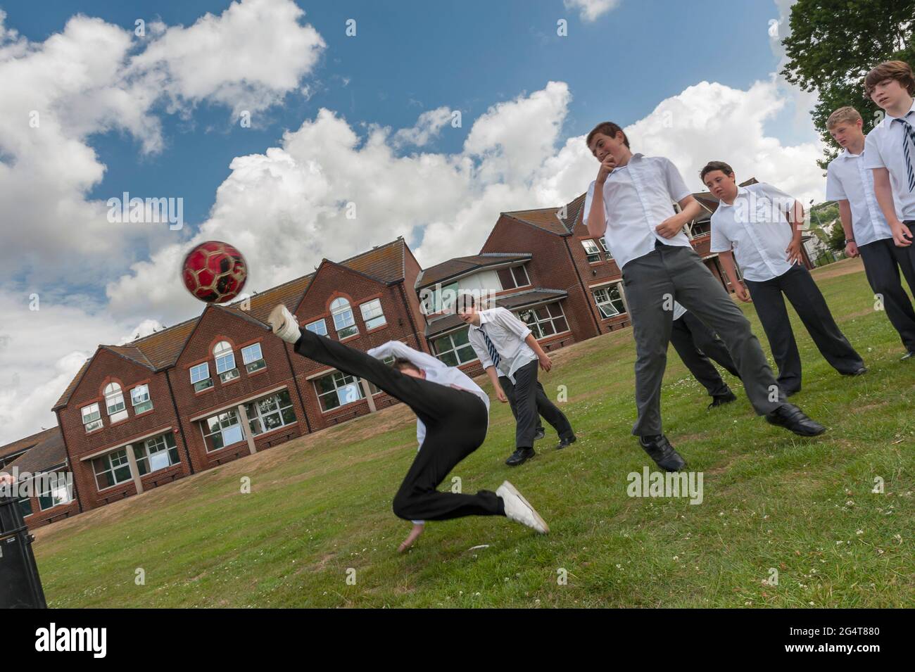 Schoolboys playing football, soccer, at breaktime, lunchtime, England, UK Stock Photo