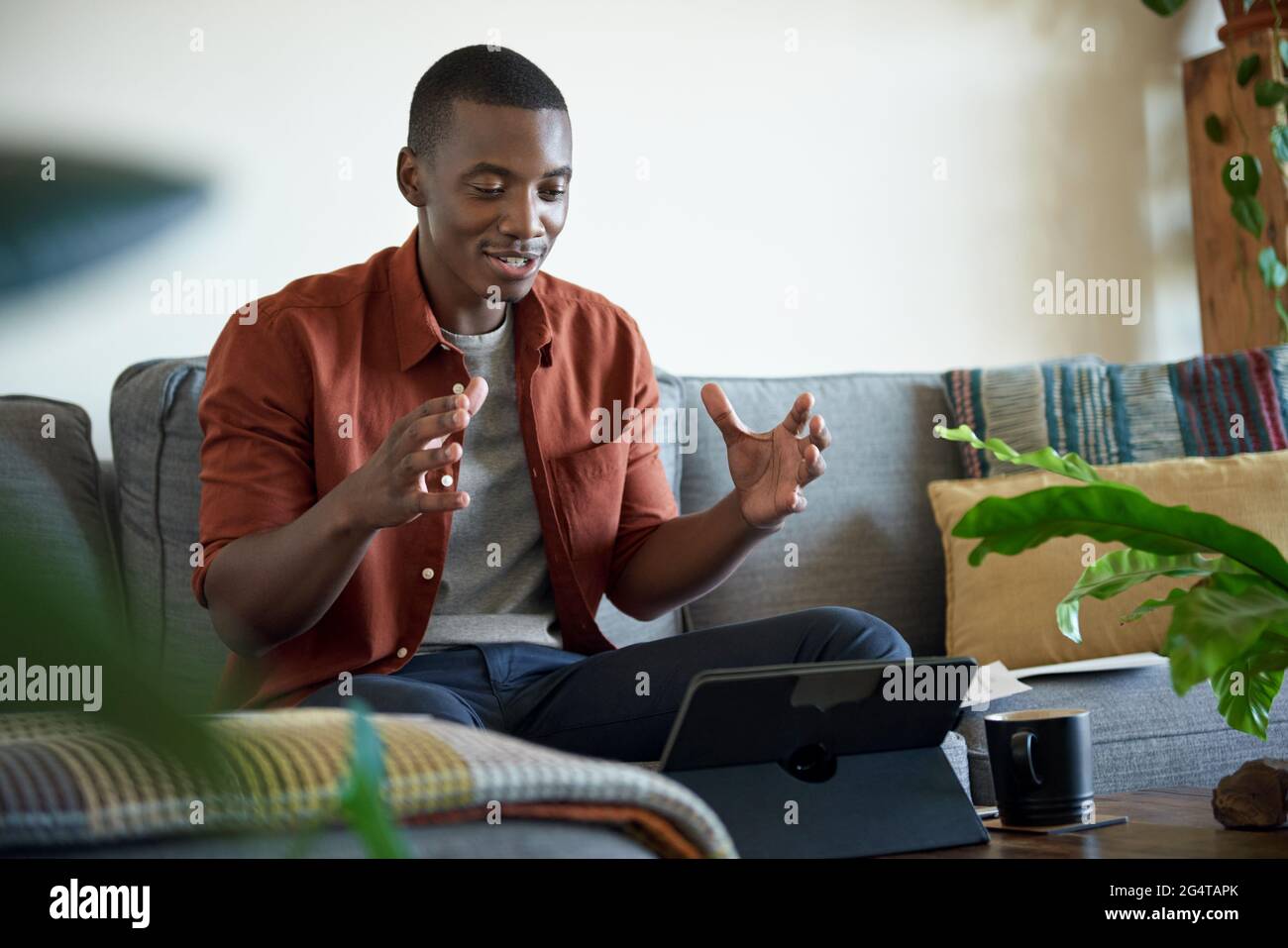 Smiling African man on a video call while working at home Stock Photo