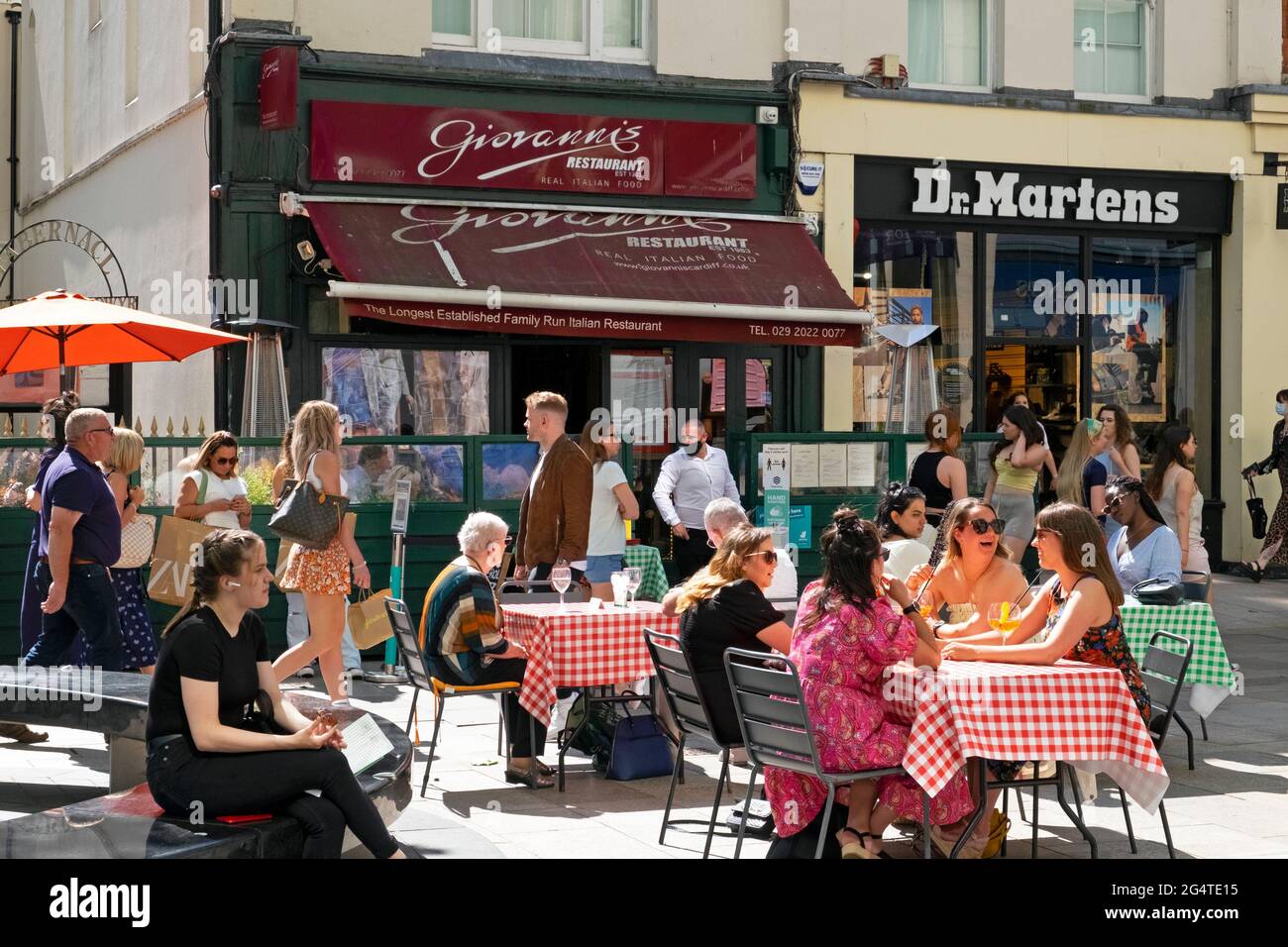 People sitting outside Giovanni's Italian restaurant eating & drinking at tables in The Hayes Cardiff City Centre Wales UK  Great Britain KATHY DEWITT Stock Photo