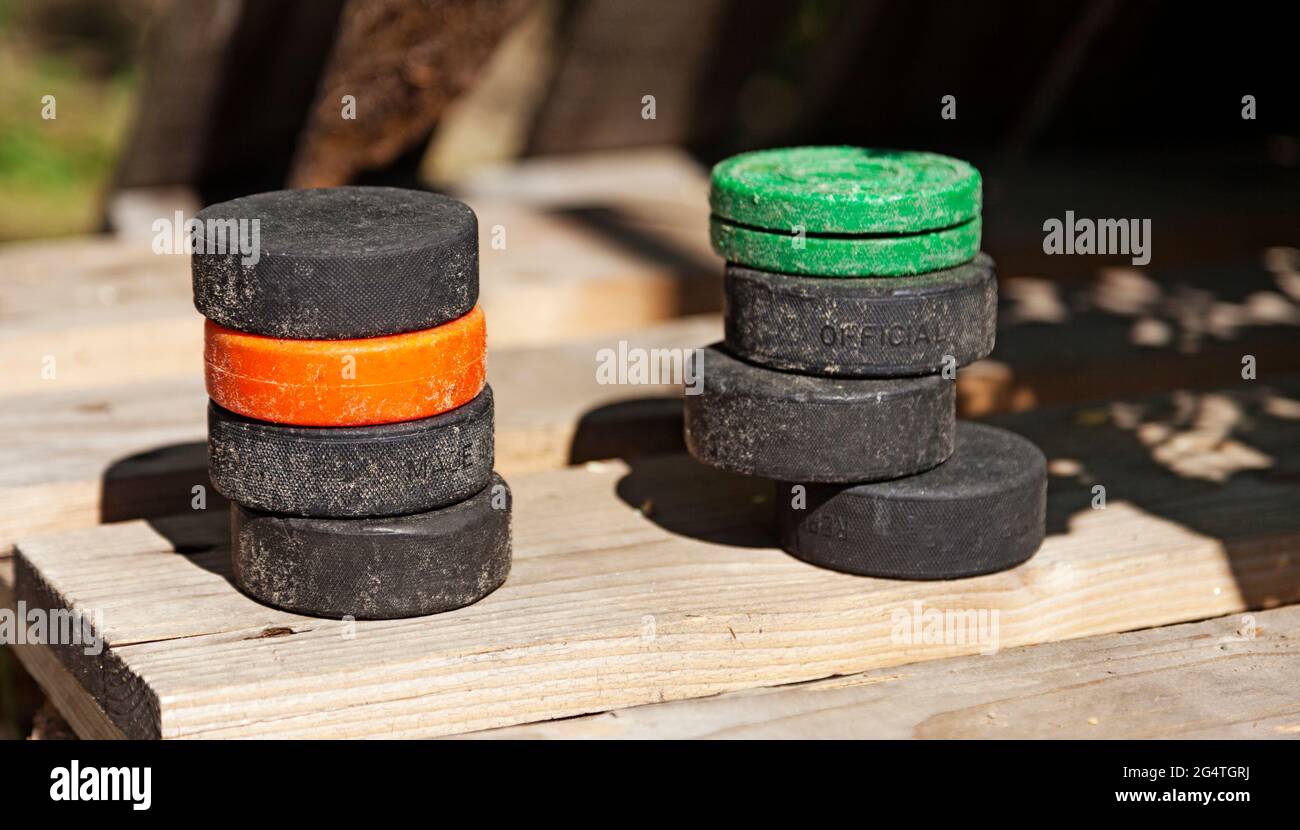 two piles of wellused hockey pucks Stock Photo Alamy