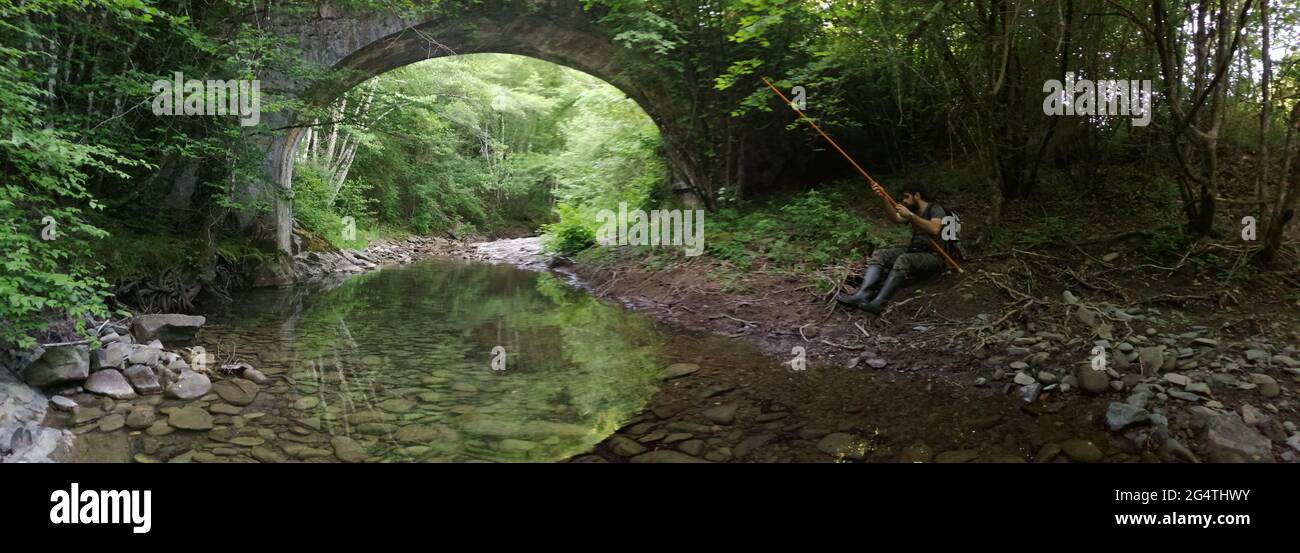 arezzo, Italy, June 13,2021: fish on a small stream in the spring, under an ancient romaqn bridge Stock Photo
