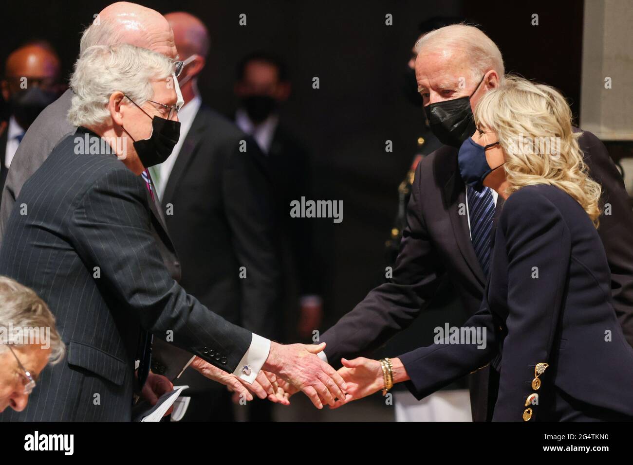 Senate Minority Leader Mitch McConnell (R-KY) greets President Joe Biden and first lady Jill Biden at the funeral ceremony of former Senator John Warner at Washington National Cathedral in Washington, DC, U.S. June 23, 2021. Oliver Contreras/Pool via REUTERS Stock Photo