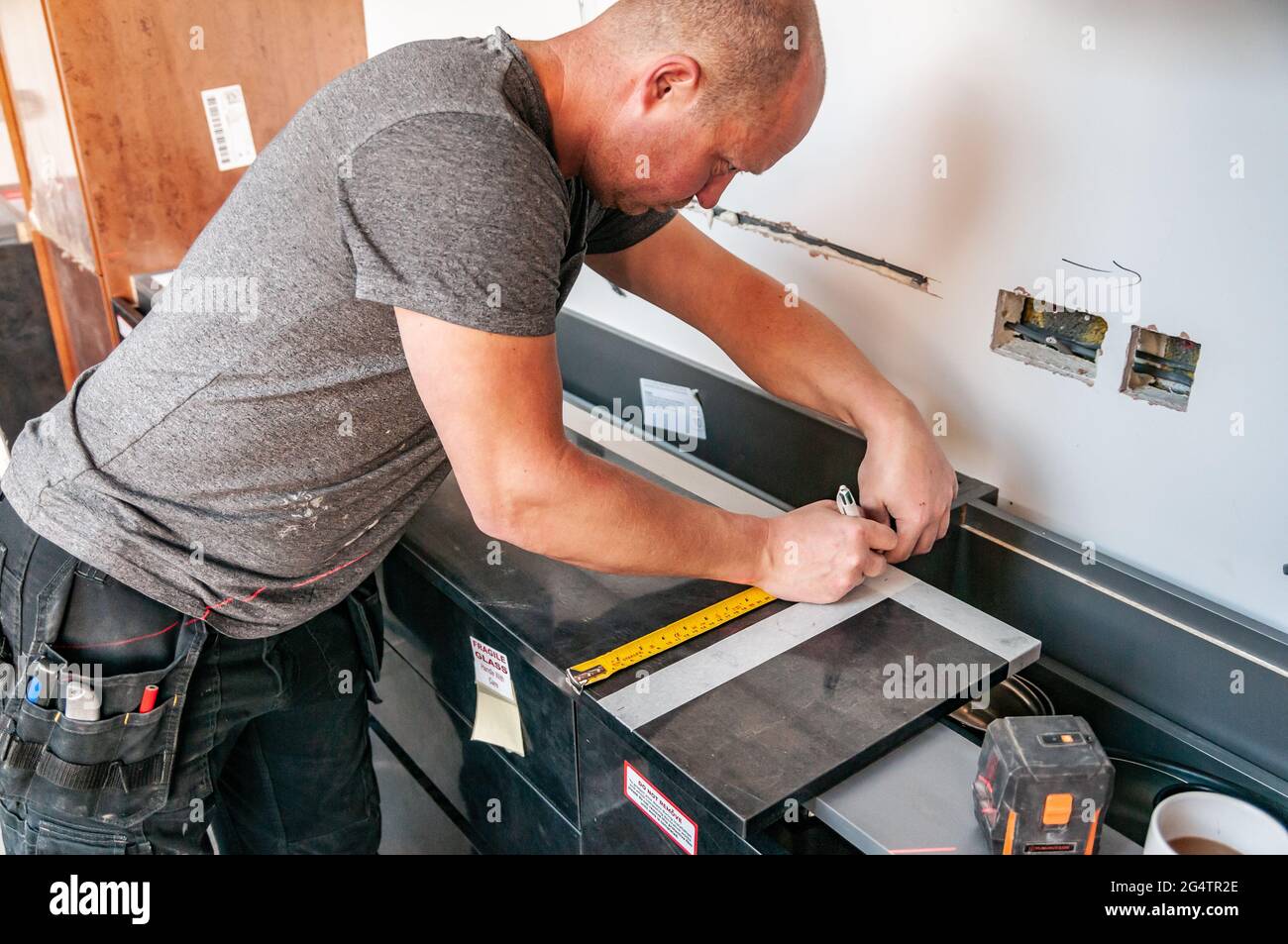 Kitchen fitter at work Stock Photo