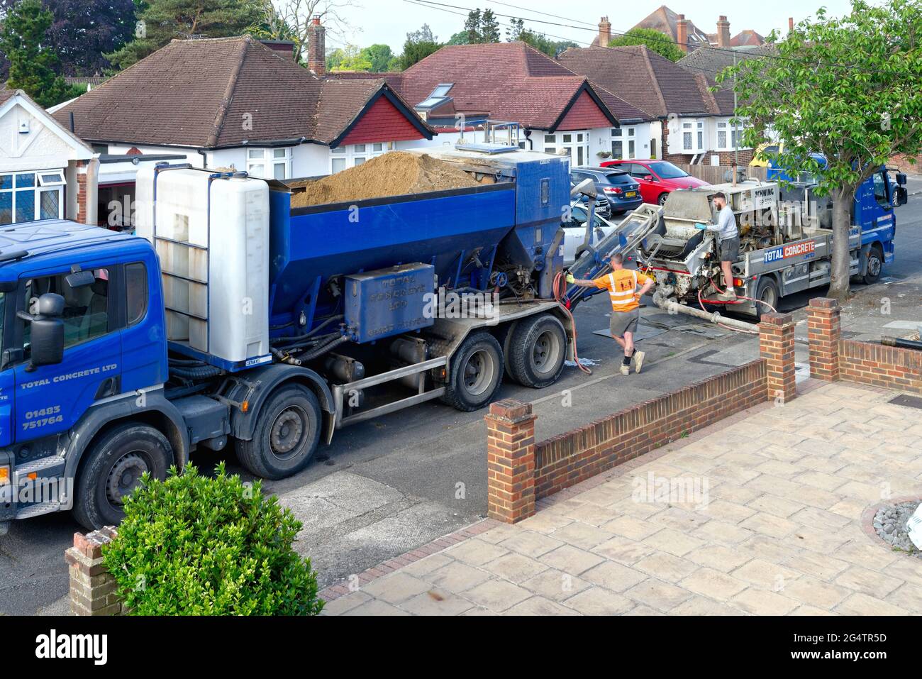 A 'Total Concrete' lorry delivering ready mix concrete roadside to a