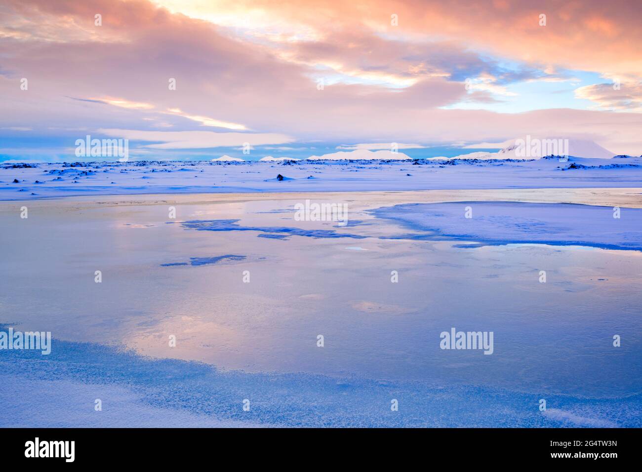 Colourful lighting at daybreak over the Námafjall region close to Hverfjall in northern Iceland during winter looking towards the Myvatnsoraefi montan Stock Photo