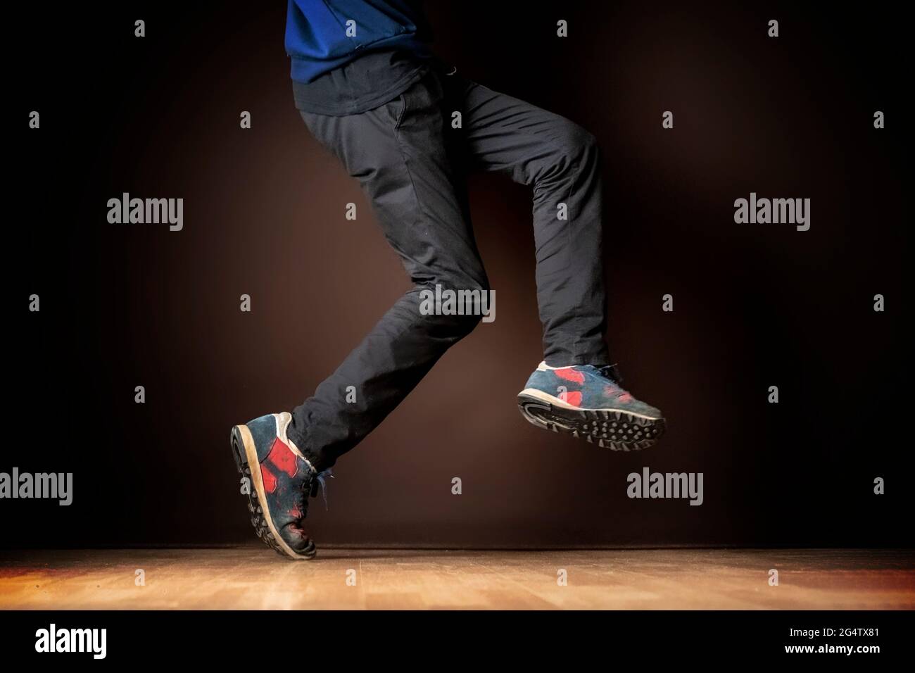 legs of male dancer on dark background Stock Photo