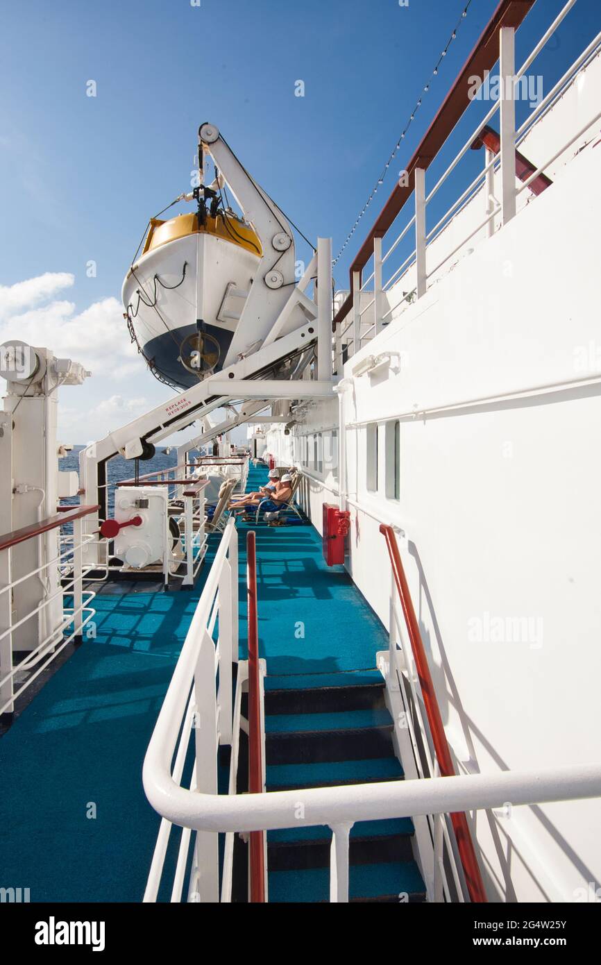 The perimeter deck of a small cruise ship with stairs leading down and ...