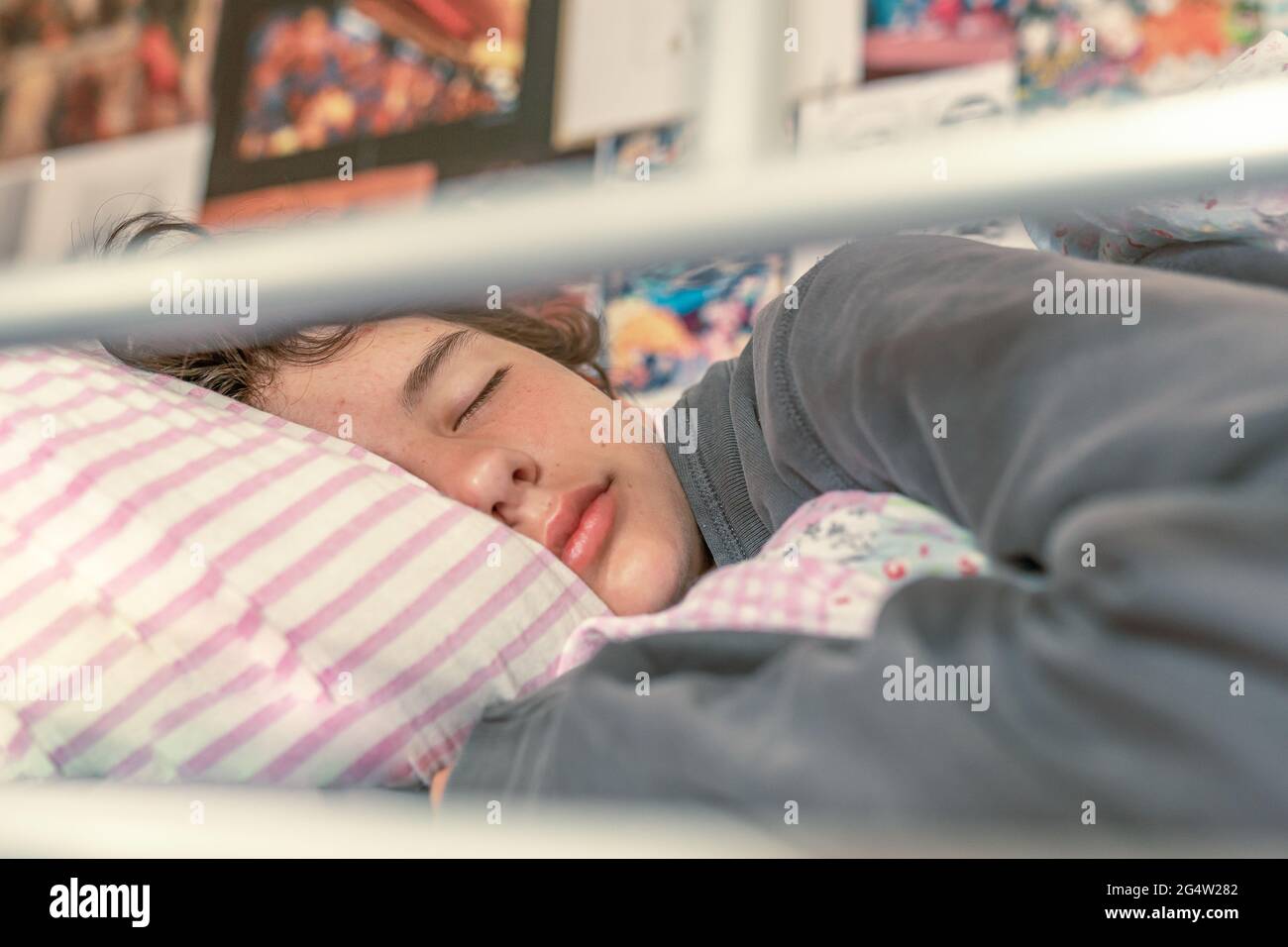 Sweet peaceful sleep of a teenage girl in a comfortable bed in a teenage room Stock Photo